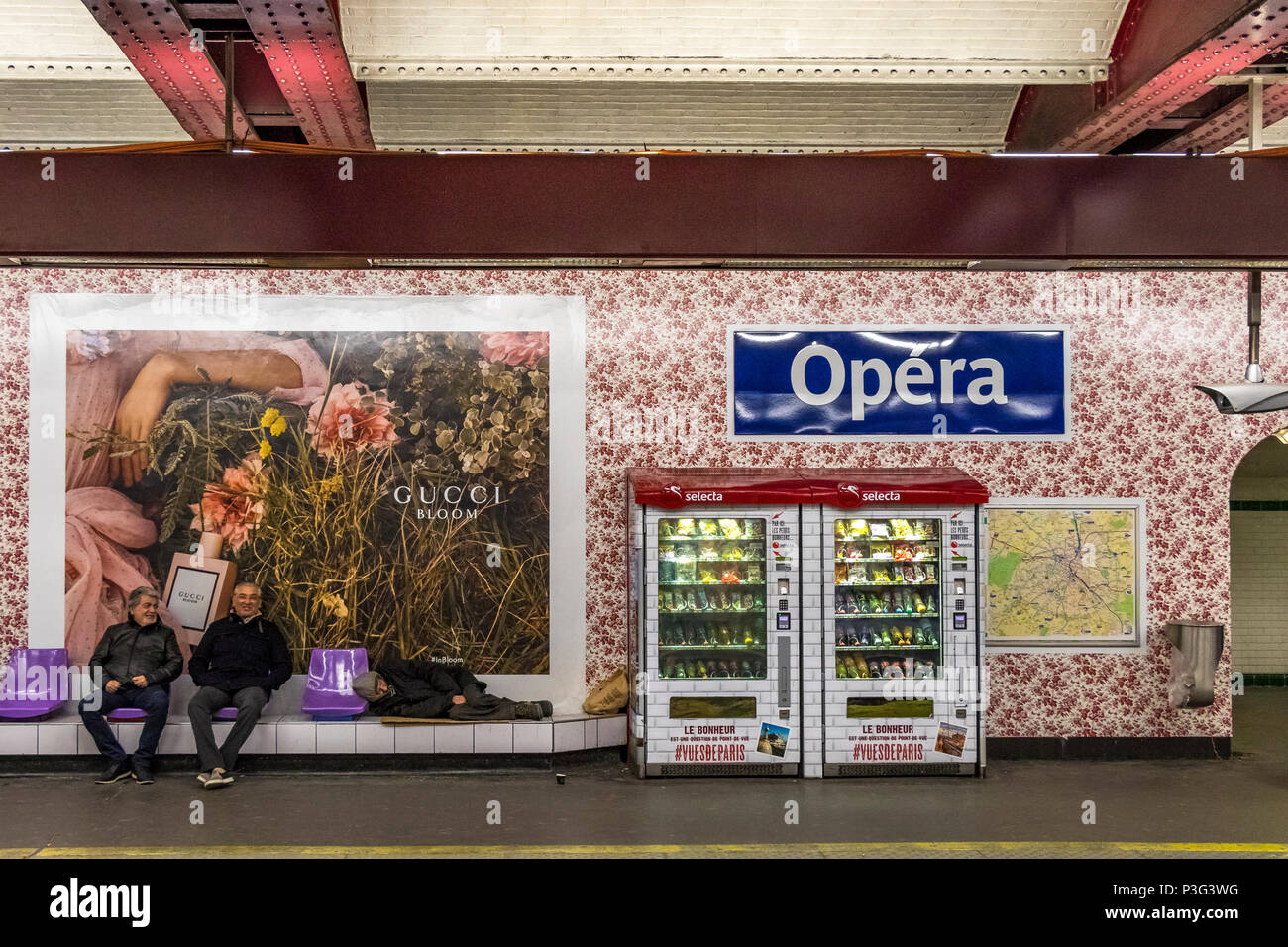 People waiting for a train on Opéra metro station in Paris .The