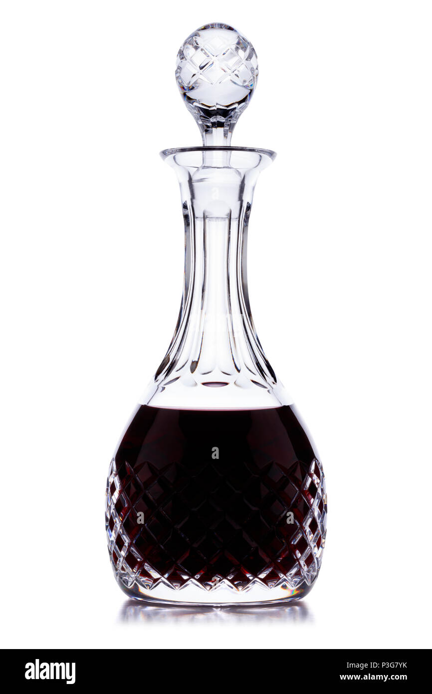 A crystal port/whine decanter, full of delicious alcohol, shot on white, with a small reflection Stock Photo