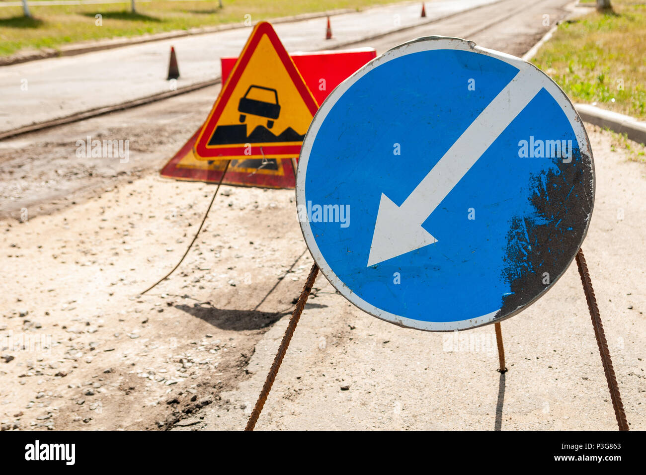 Road signs detour on the left road repair Stock Photo - Alamy