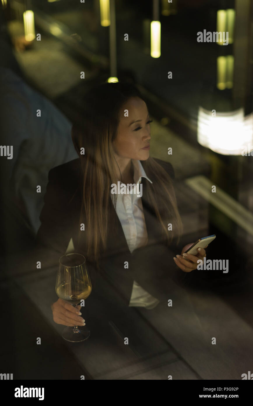 Businesswoman looking away while having champagne Stock Photo