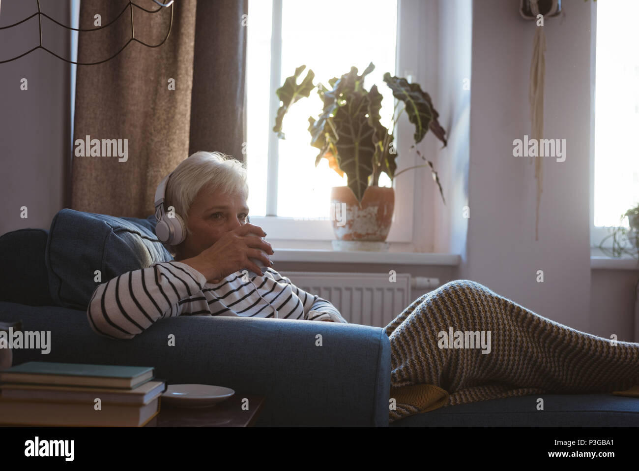 Woman relaxing sofa hi-res stock photography and images - Alamy