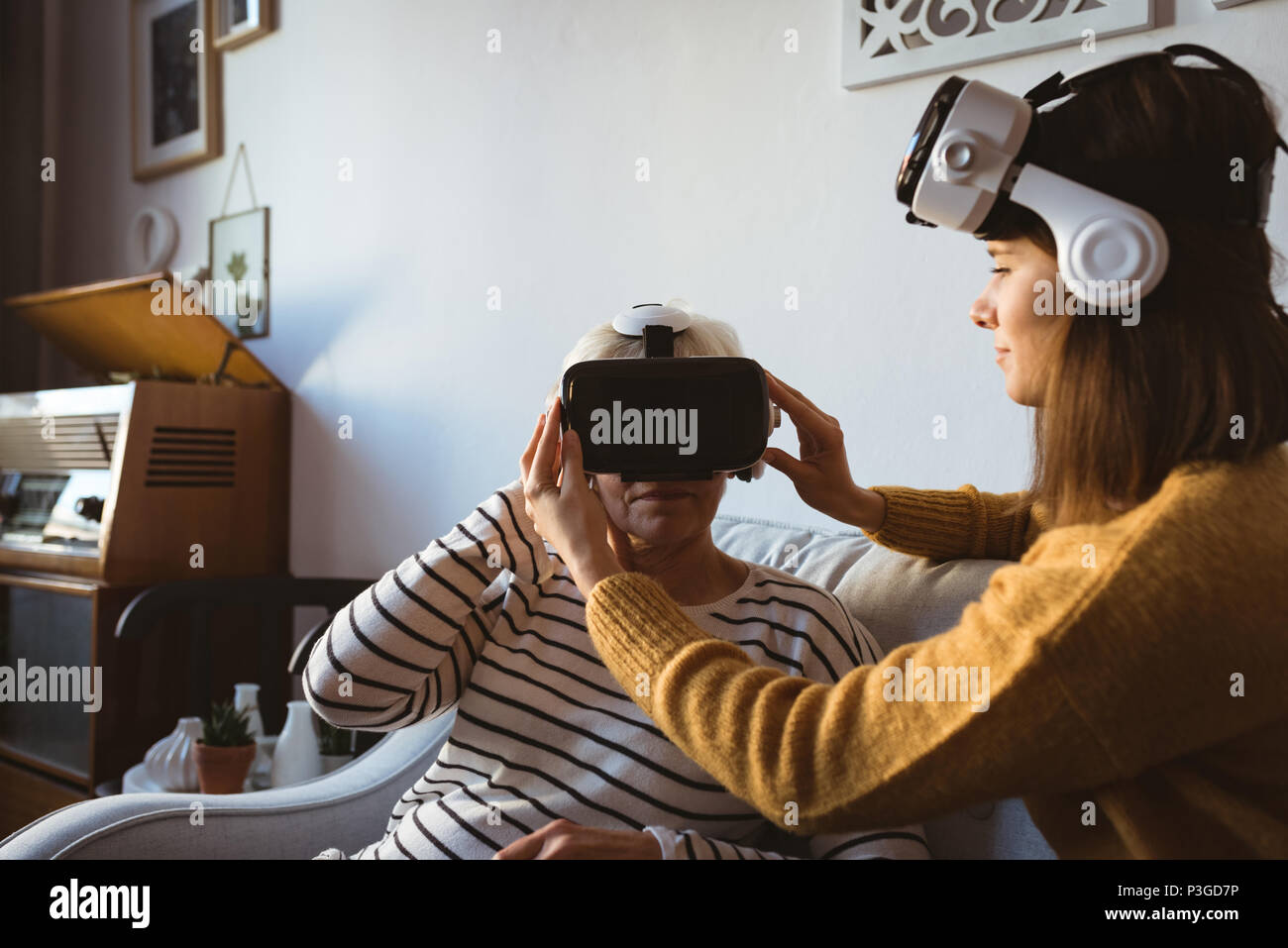Senior woman and daughter wearing a virtual reality headset Stock Photo ...