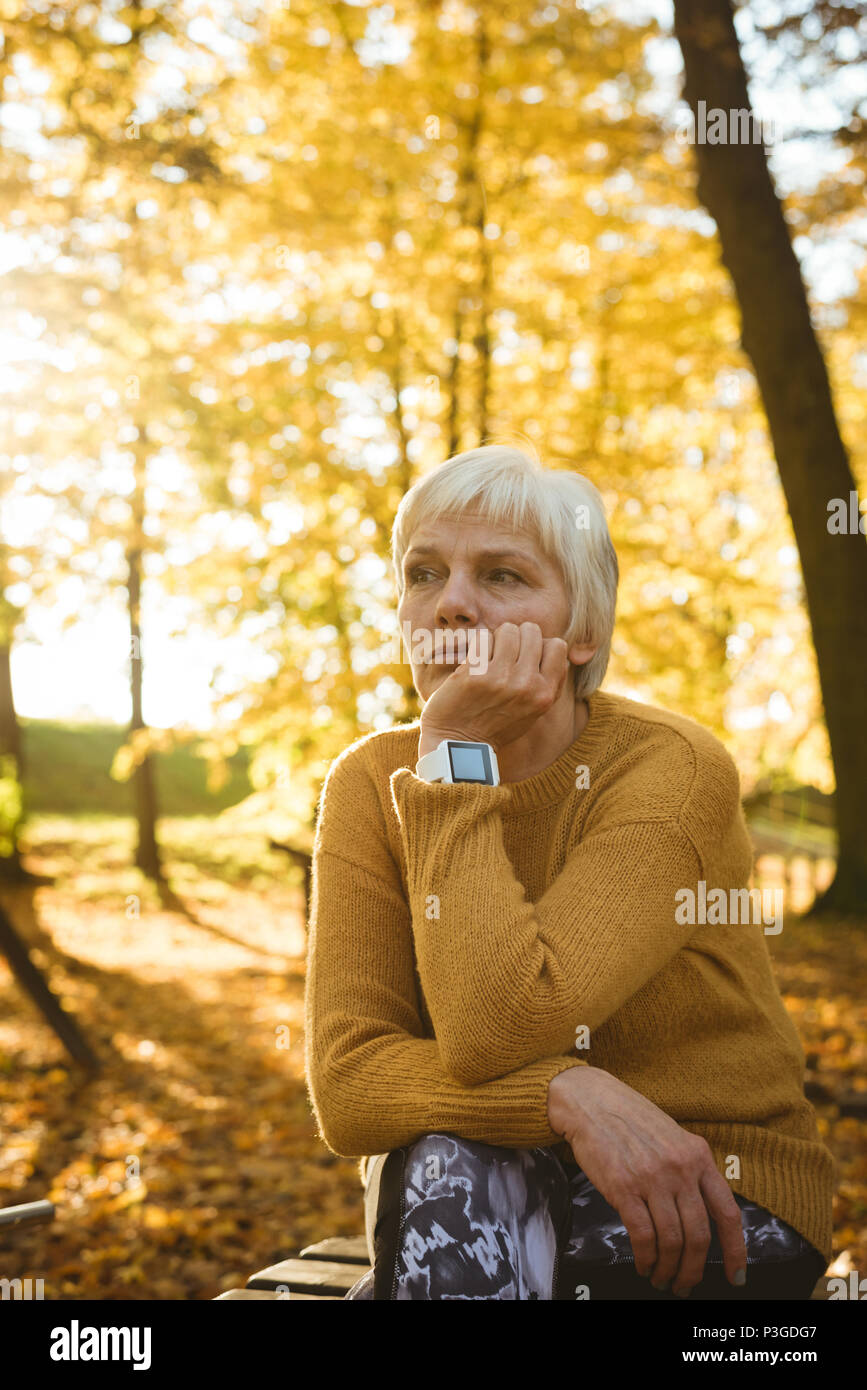 Mature woman thinking sitting bench hi-res stock photography and images ...