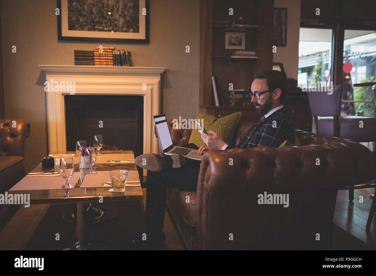 Businessman using laptop and mobile phone Stock Photo