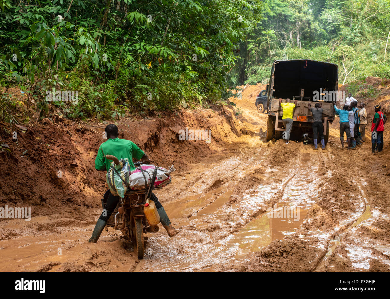 Motorcycle on a muddy logging road near Kribi, Cameroon Stock Photo