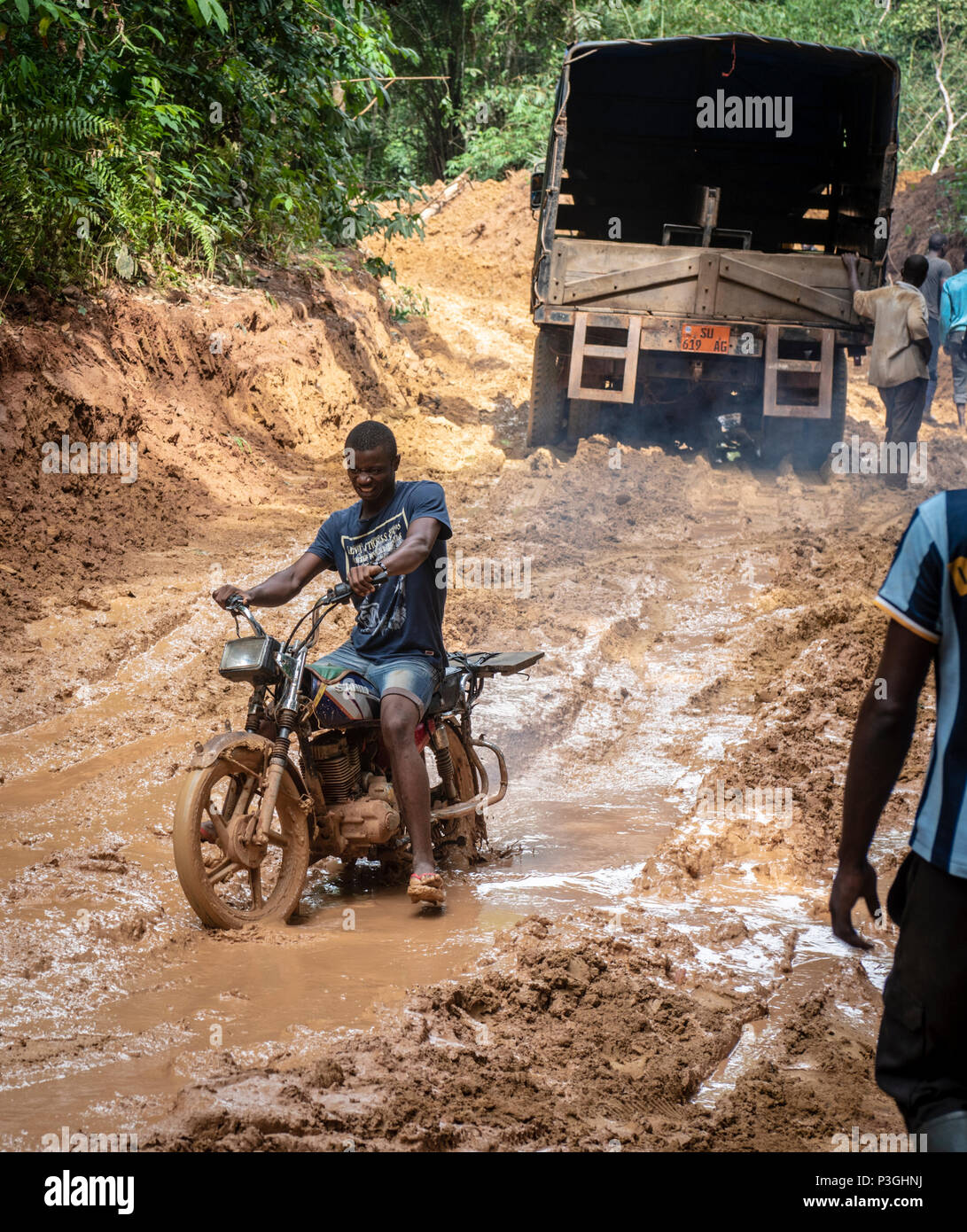 Motorcycle on a muddy logging road near Kribi, Cameroon Stock Photo