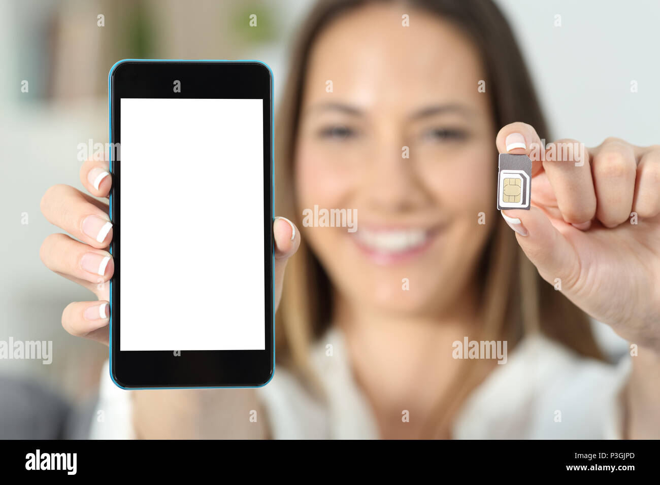 Close up of a happy woman hand showing a sim card and a smart phone Stock Photo Alamy