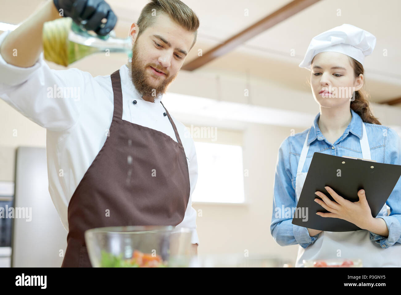 Young Chef Working in Restaurant Stock Photo