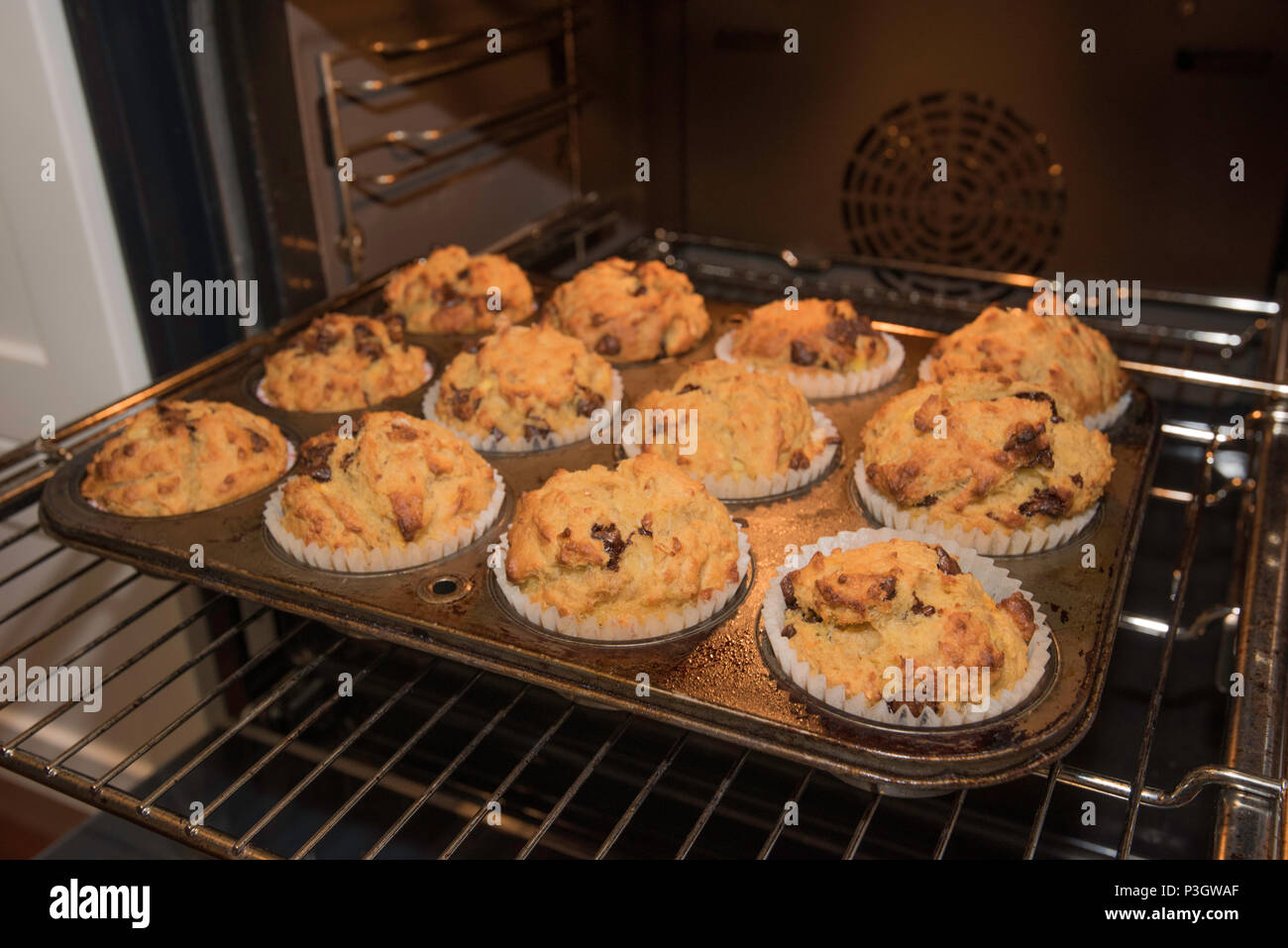Home baked golden choc chip, banana and cereal muffins prepared in a kitchen in Sydney, Australia just out of the oven Stock Photo