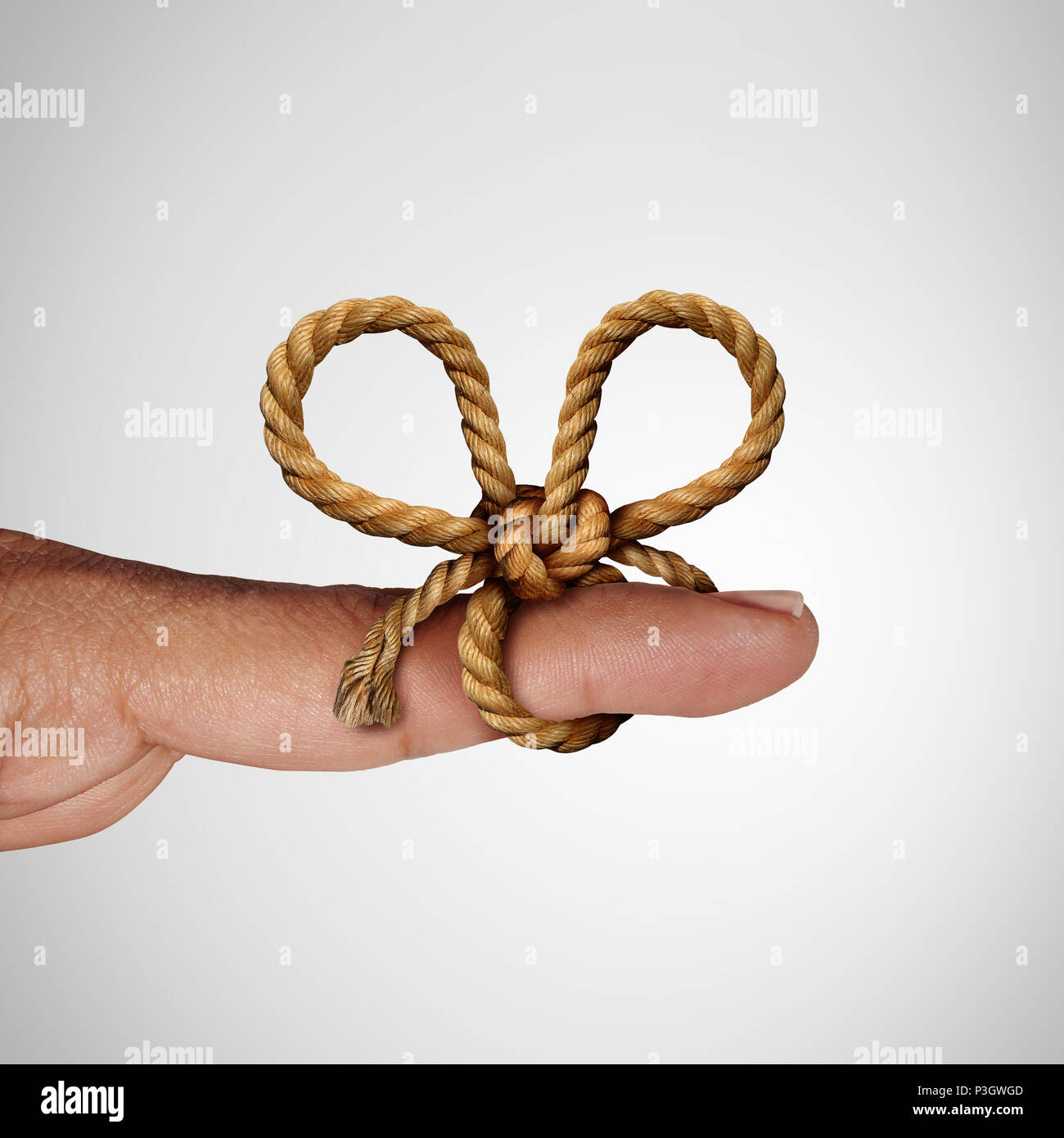 Remember knot and reminder symbol as a string tied on a finger to remind and give attention to a future planned event. Stock Photo