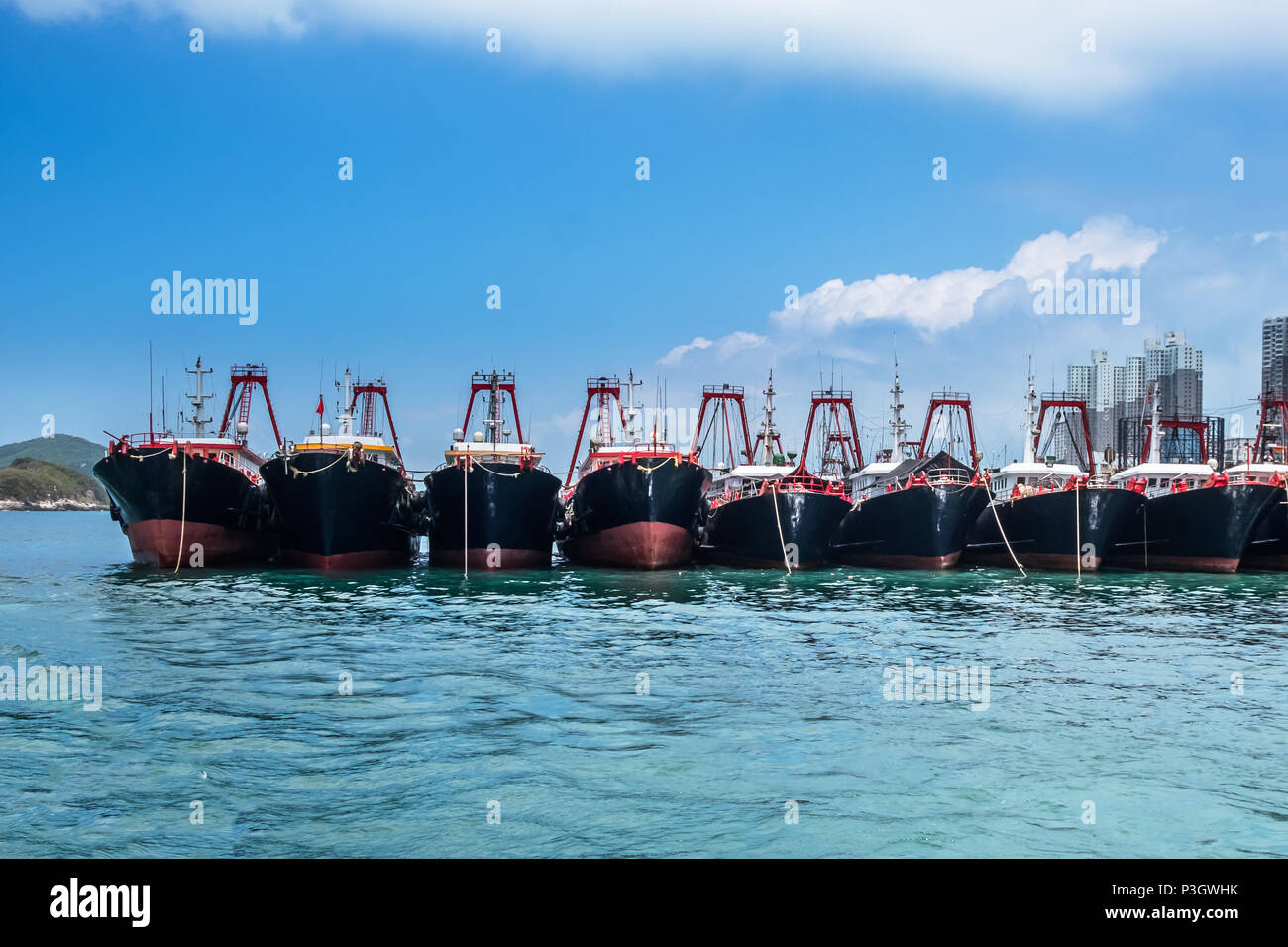 Fishing trawlers anchored in Aberdeen Bay, Hong Kong. Modern nautical vessels in fish industry. Stock Photo