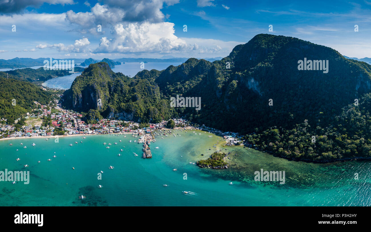 Aerial drone view of boats and mountains surrounding the town of El Nido in Palawan Stock Photo