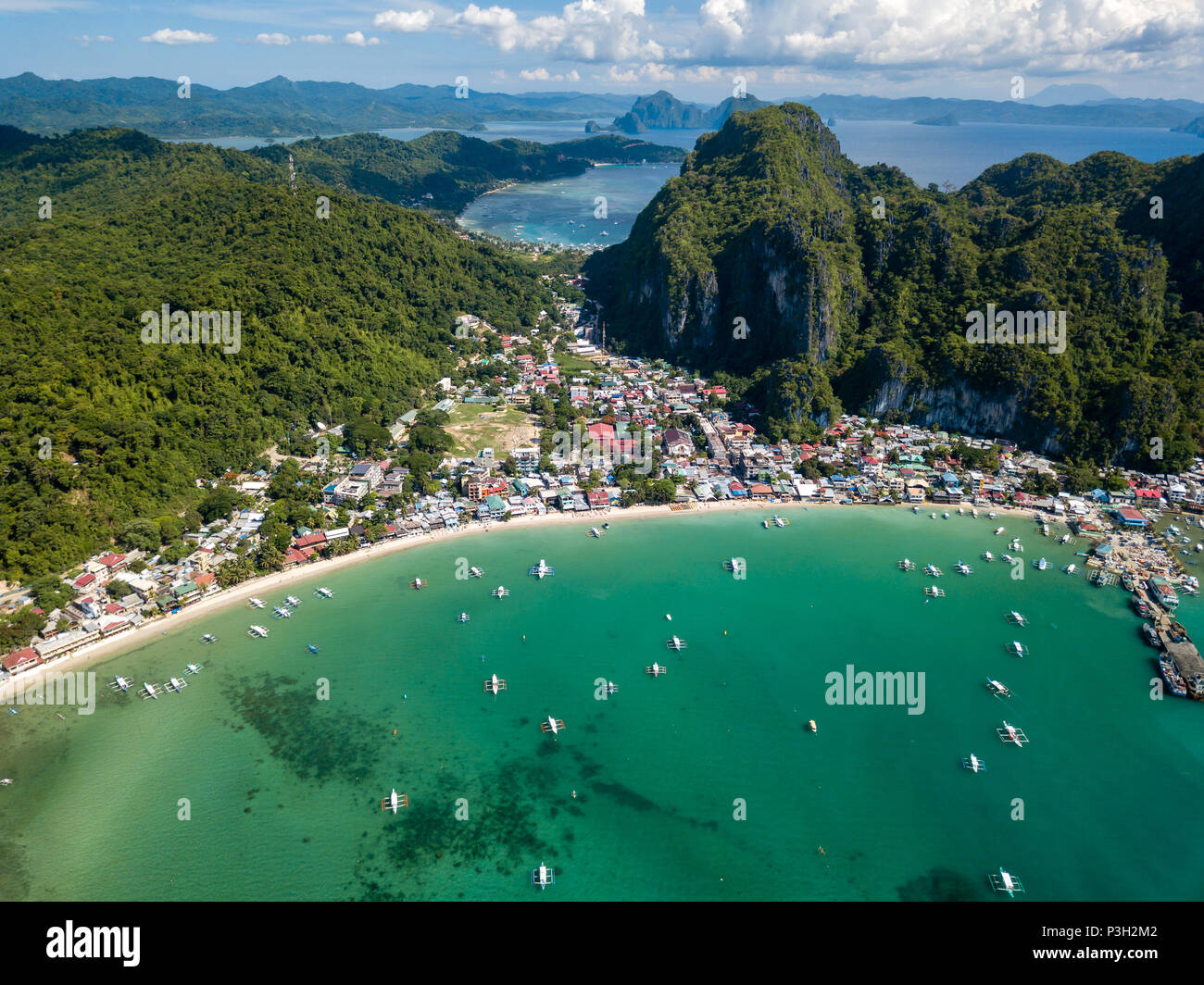 Aerial drone view of boats and mountains surrounding the town of El Nido in Palawan Stock Photo