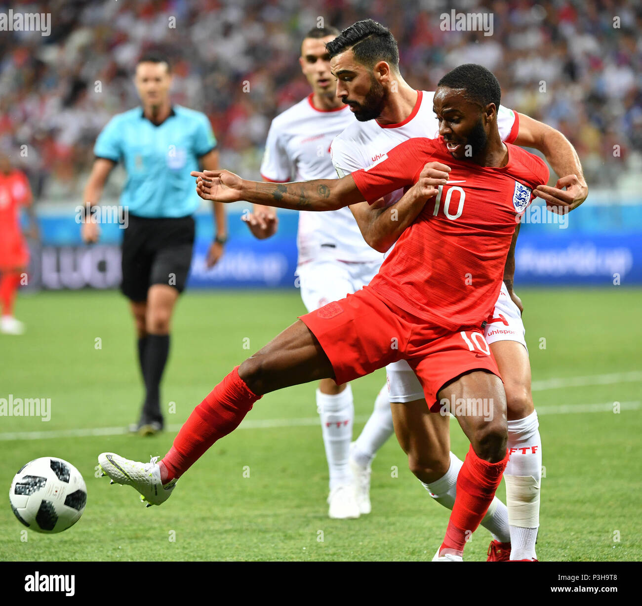Volgograd, Russia. 18th June, 2018. Raheem Sterling (front) of England vies with Yassine Meriah of Tunisia during a group G match between Tunisia and England at the 2018 FIFA World Cup in Volgograd, Russia, June 18, 2018. Credit: Liu Dawei/Xinhua/Alamy Live News Stock Photo