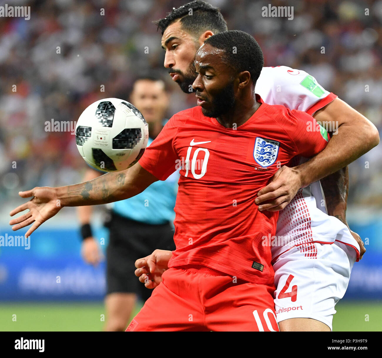 Volgograd, Russia. 18th June, 2018. Raheem Sterling (front) of England vies with Yassine Meriah of Tunisia during a group G match between Tunisia and England at the 2018 FIFA World Cup in Volgograd, Russia, June 18, 2018. Credit: Liu Dawei/Xinhua/Alamy Live News Stock Photo