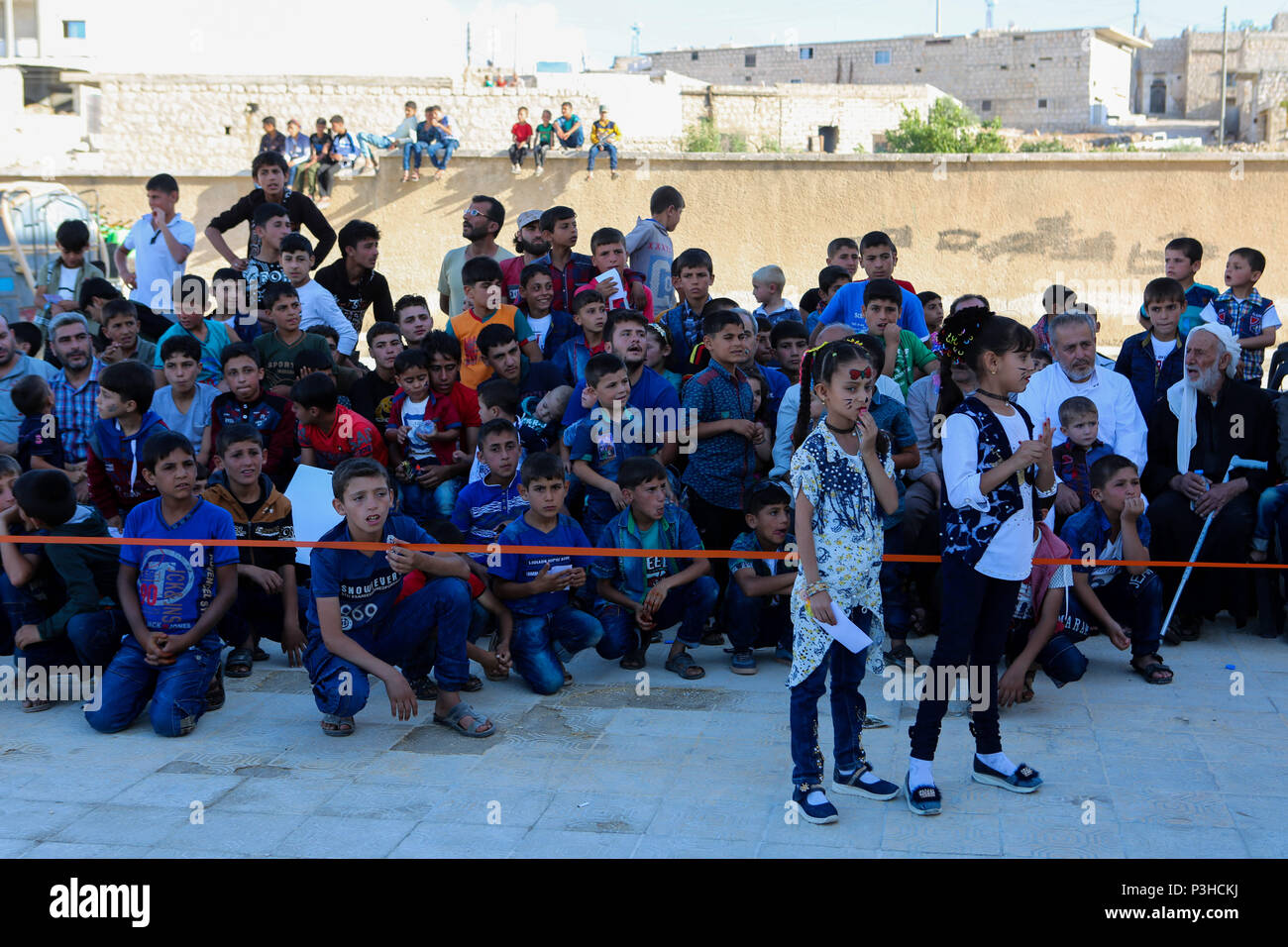June 17, 2018 - A day of entertainment is held for orphan children in the Syrian town of Taqad, near Aleppo western countryside, on the third day of the Eid Al-Fitr feast. All the orphans of Taqd attended the event, joining a number of playful children activities, and receiving gifts before being given dinner Credit: Juma Mohammad/IMAGESLIVE/ZUMA Wire/Alamy Live News Stock Photo