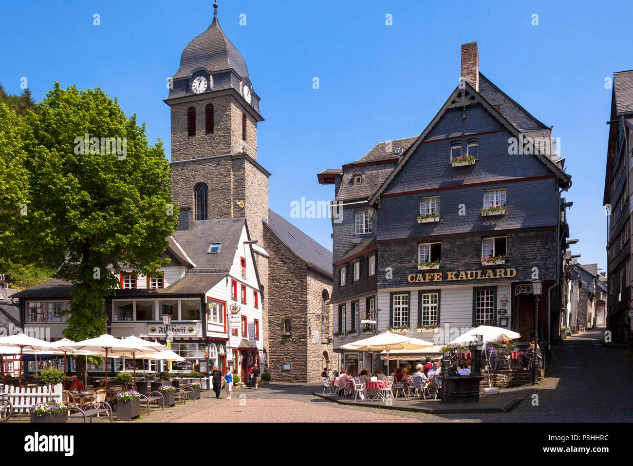 Germany, Eifel region, the city of Monschau, the Au church Sankt Maria Empfaengnis and the cafe Kaulard at the market square in the historic town.  De Stock Photo