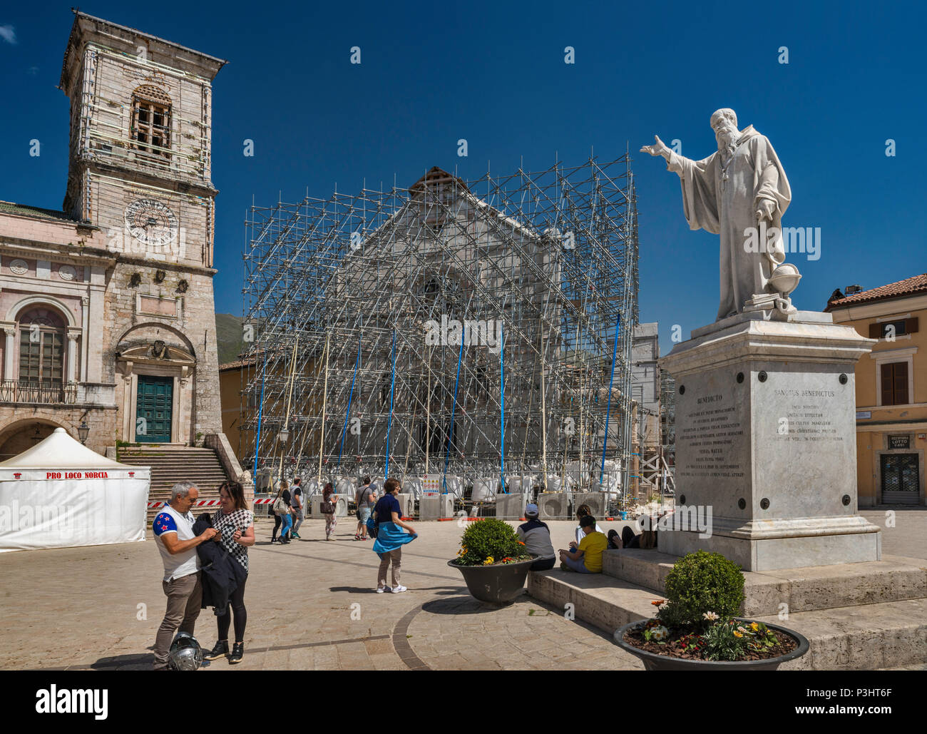 San Benedetto Monument, and facade, supported by scaffolding, of Basilica, destroyed by earthquakes, April 2018 view, in Norcia, Umbria, Italy Stock Photo