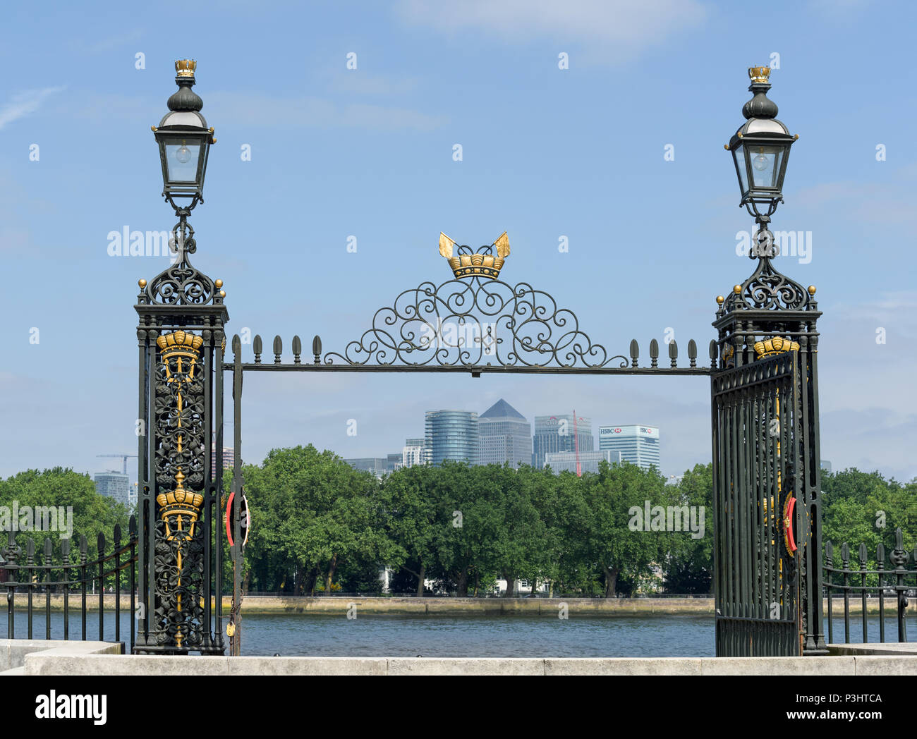 Wrought iron gate of the royal naval college at Greenwich, London, England, looking out across the river Thames to the Isle of Dogs and Canary Wharf. Stock Photo