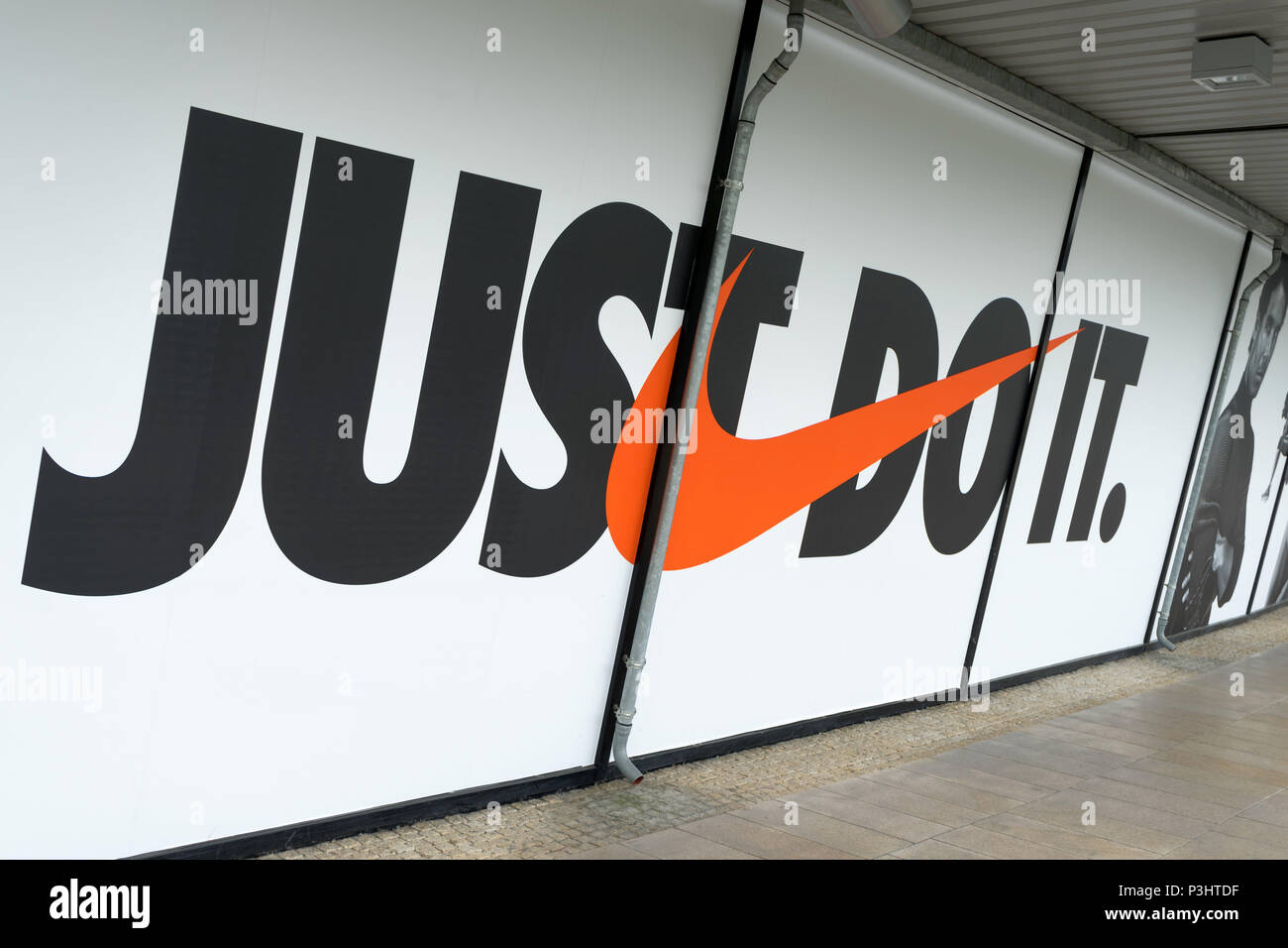 The Nike logo and Nike motto "just do it" on the window display in an  outlet in Wolfsburg, Germany, June 15, 2018 Stock Photo - Alamy
