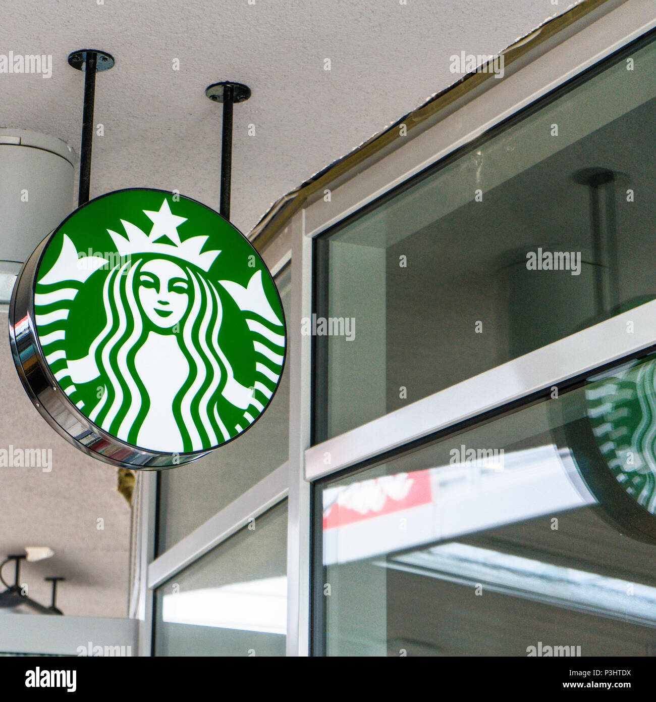 The starbucks logo on the ceiling in front of a store in an outlet in Wolfsburg, Germany, June 15, 2018 Stock Photo