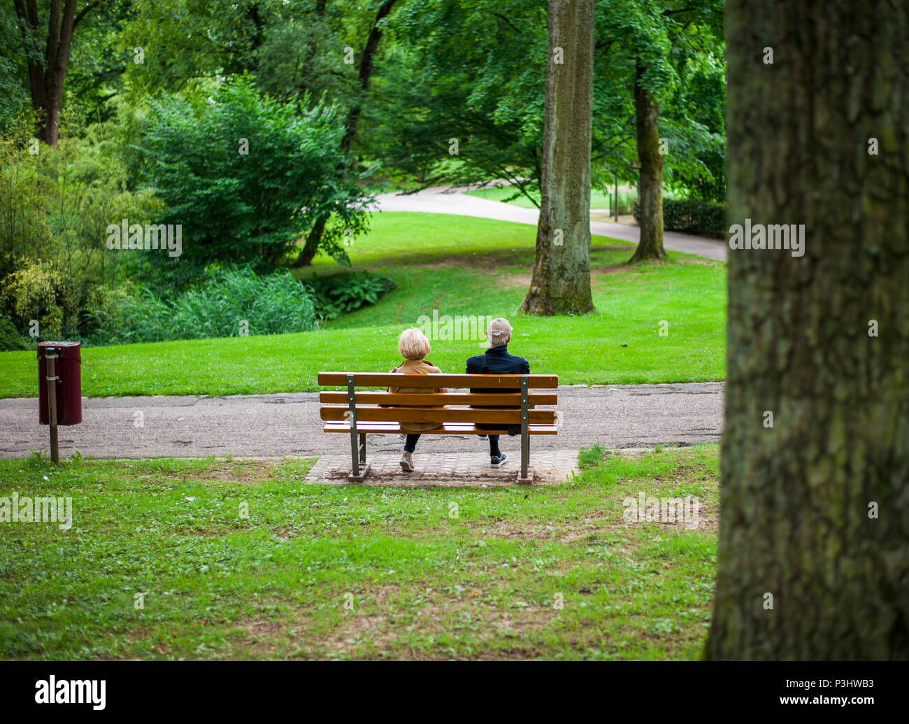 An old couple sitting on the bench in a public park, Luxembourg Stock Photo