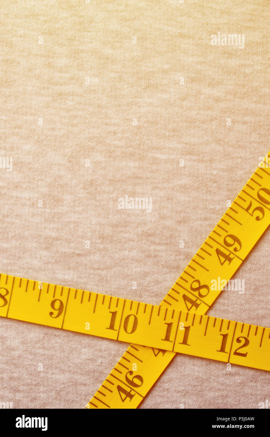 https://c8.alamy.com/comp/P3J0AW/the-measuring-tape-of-yellow-color-with-numerical-indicators-in-the-form-of-centimeters-or-inches-lies-on-a-gray-knitted-fabric-background-concept-fo-P3J0AW.jpg