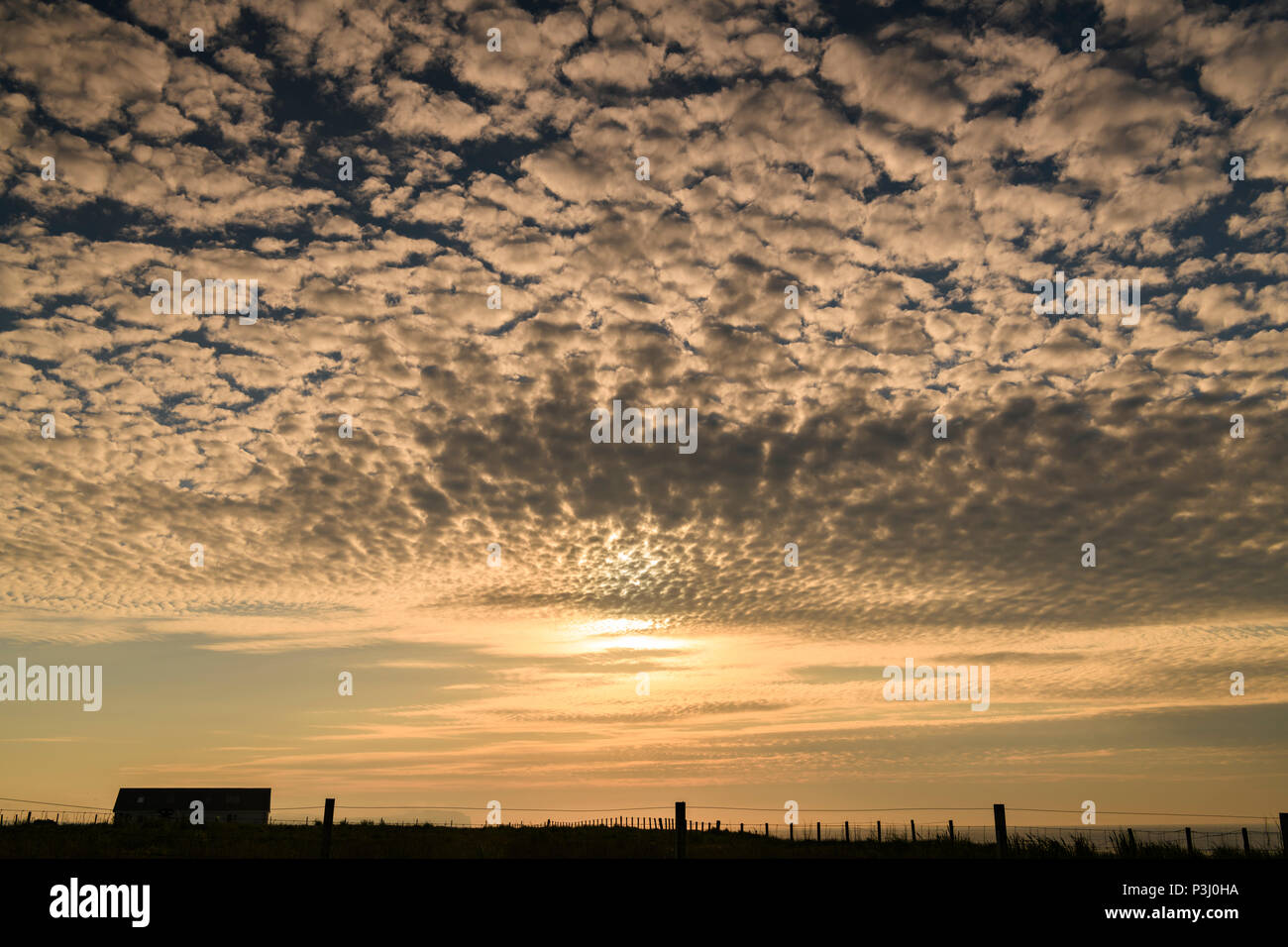 Middle altitude Altocumulus Stratiformis clouds at sunset over the Pentland Firth, Caithness, Scotland. 29 May 2018 Stock Photo