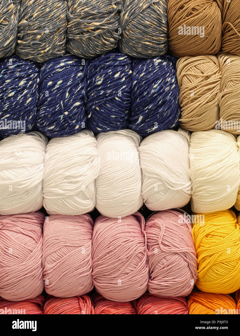 A lot of soft wool balls for sale in the knitwear shop Stock Photo