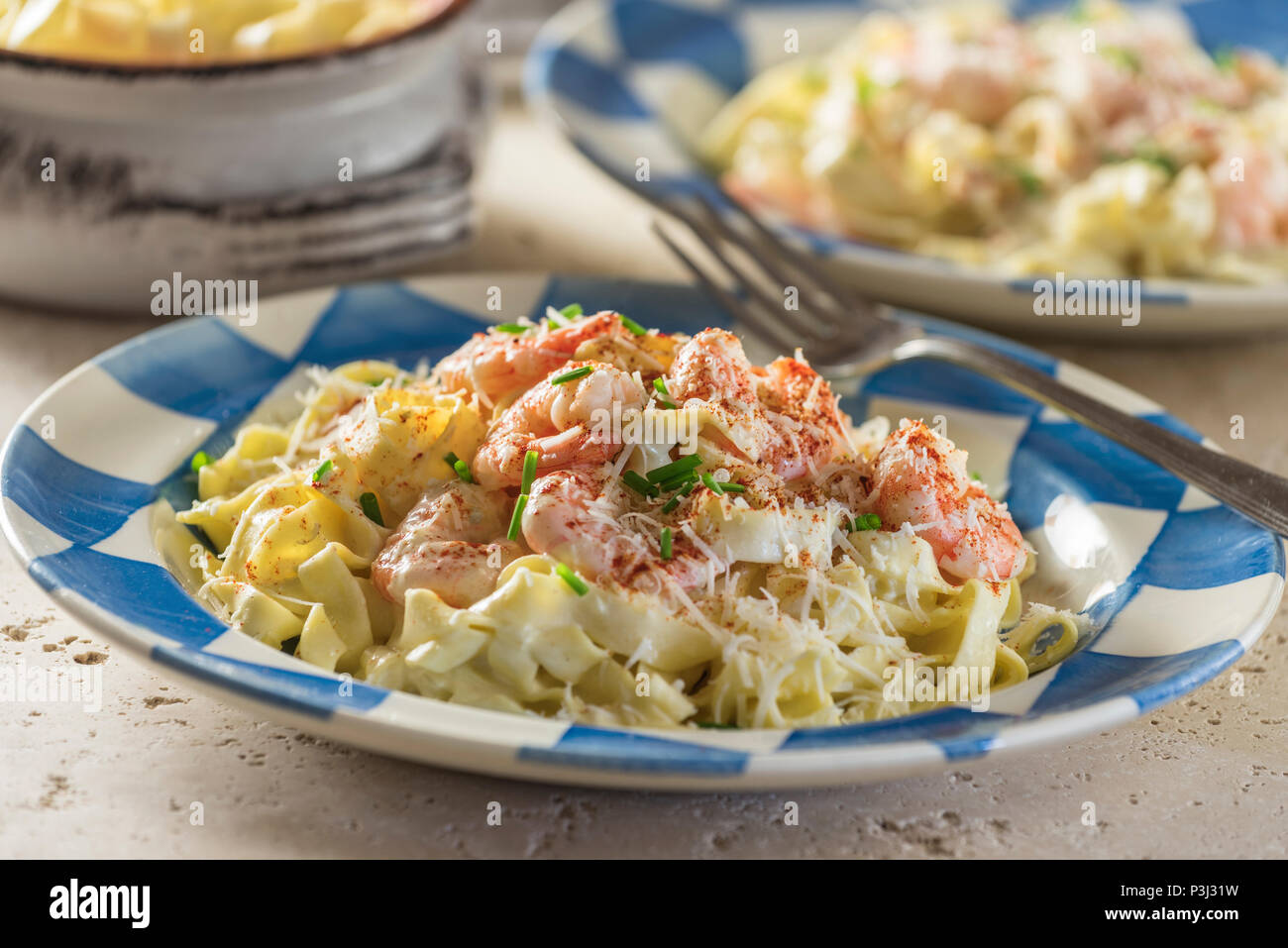Shrimp Fettuccine Alfredo. Pasta in cheese and butter sauce with prawns. Stock Photo