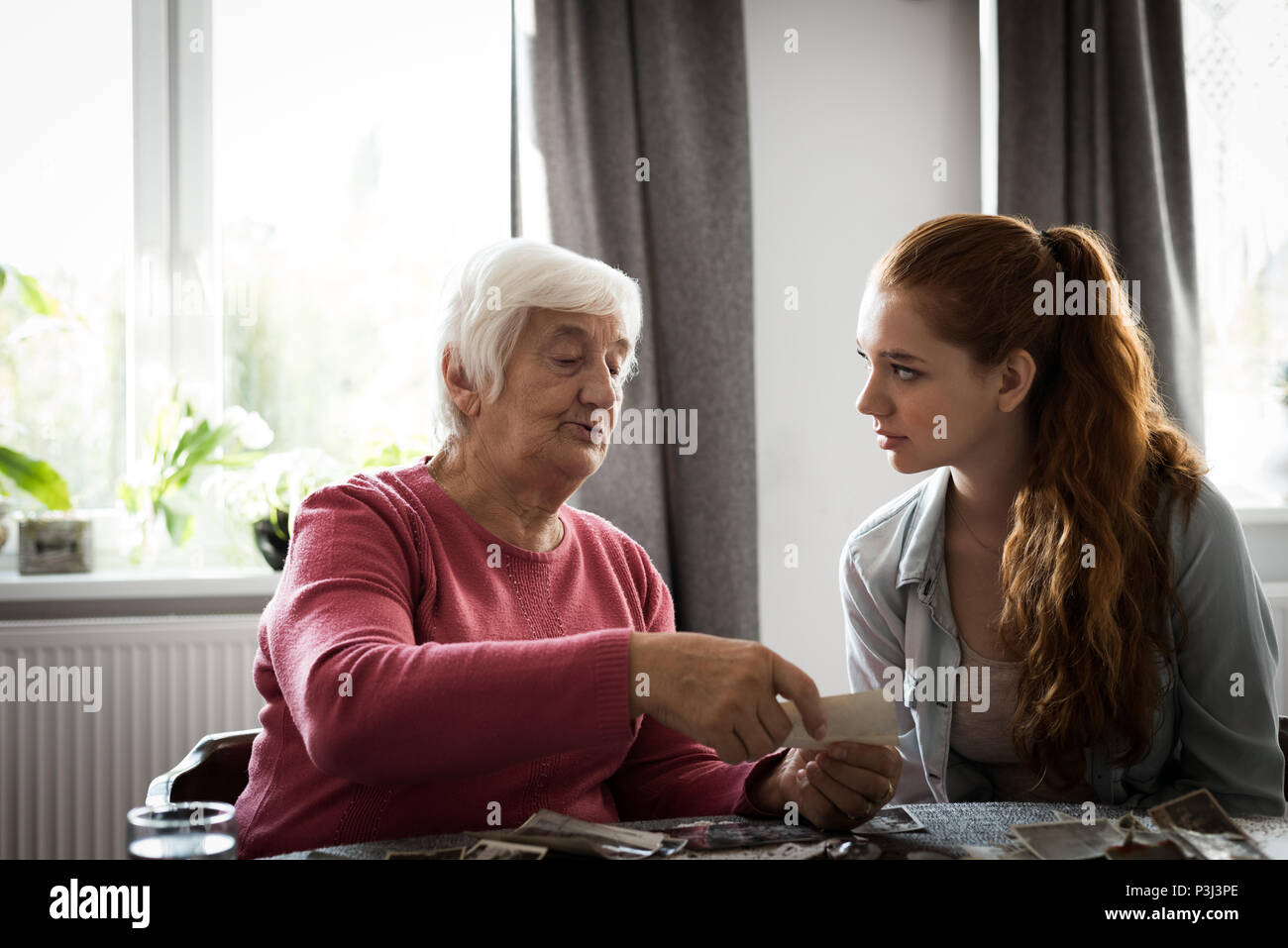 Grandmother and grand daughter interacting with each other Stock Photo