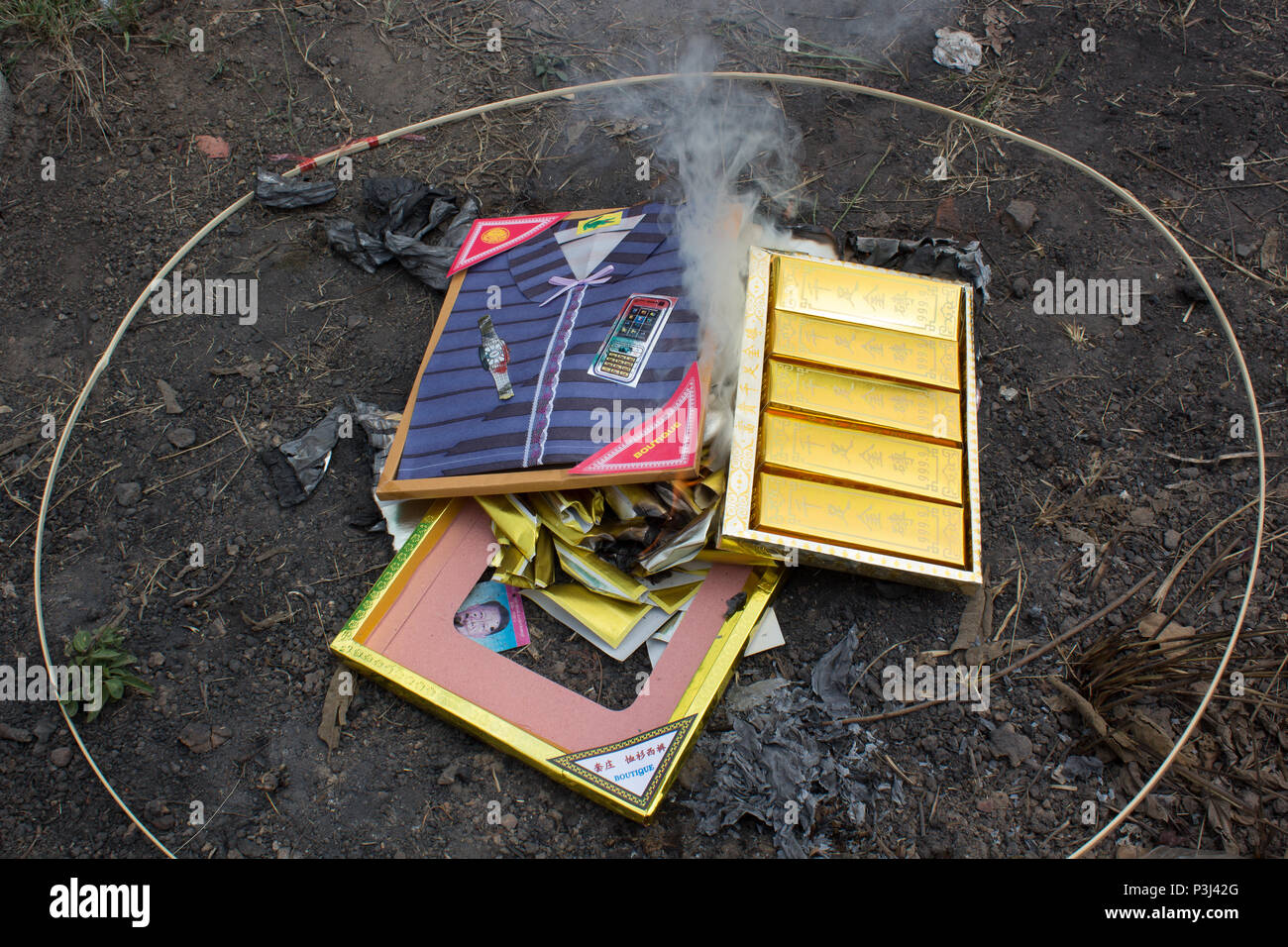 Burning paper clothes in Ching Ming festival for ancestor Stock Photo