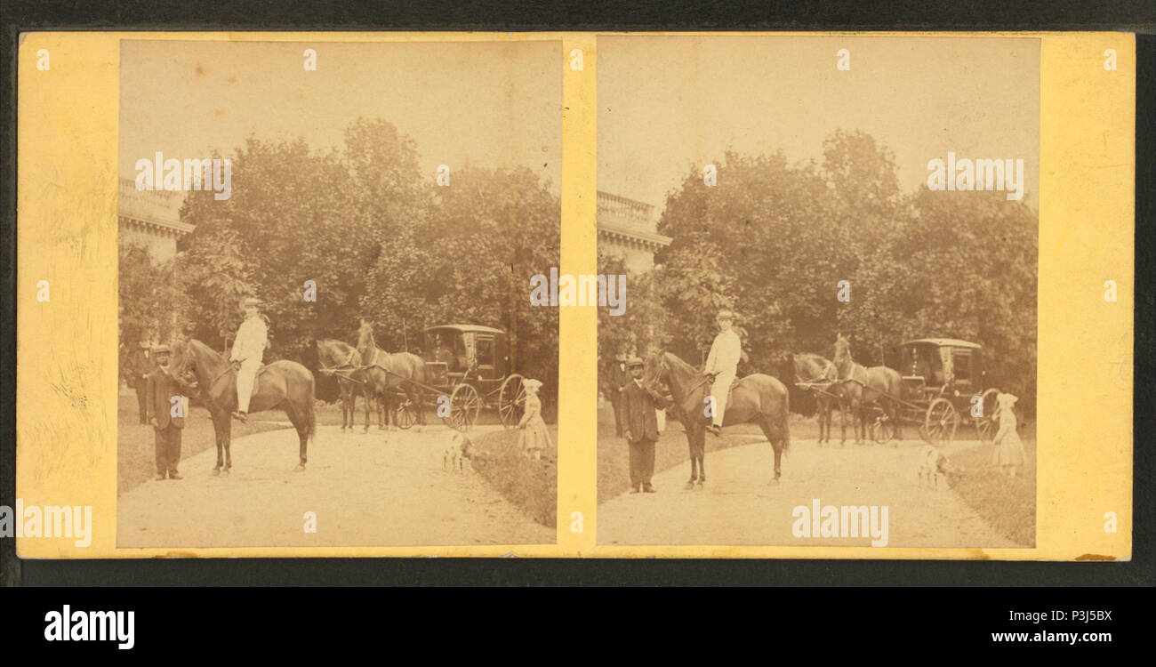 357 View of African American groom holding reins of horse with rider, from Robert N. Dennis collection of stereoscopic views 2 Stock Photo
