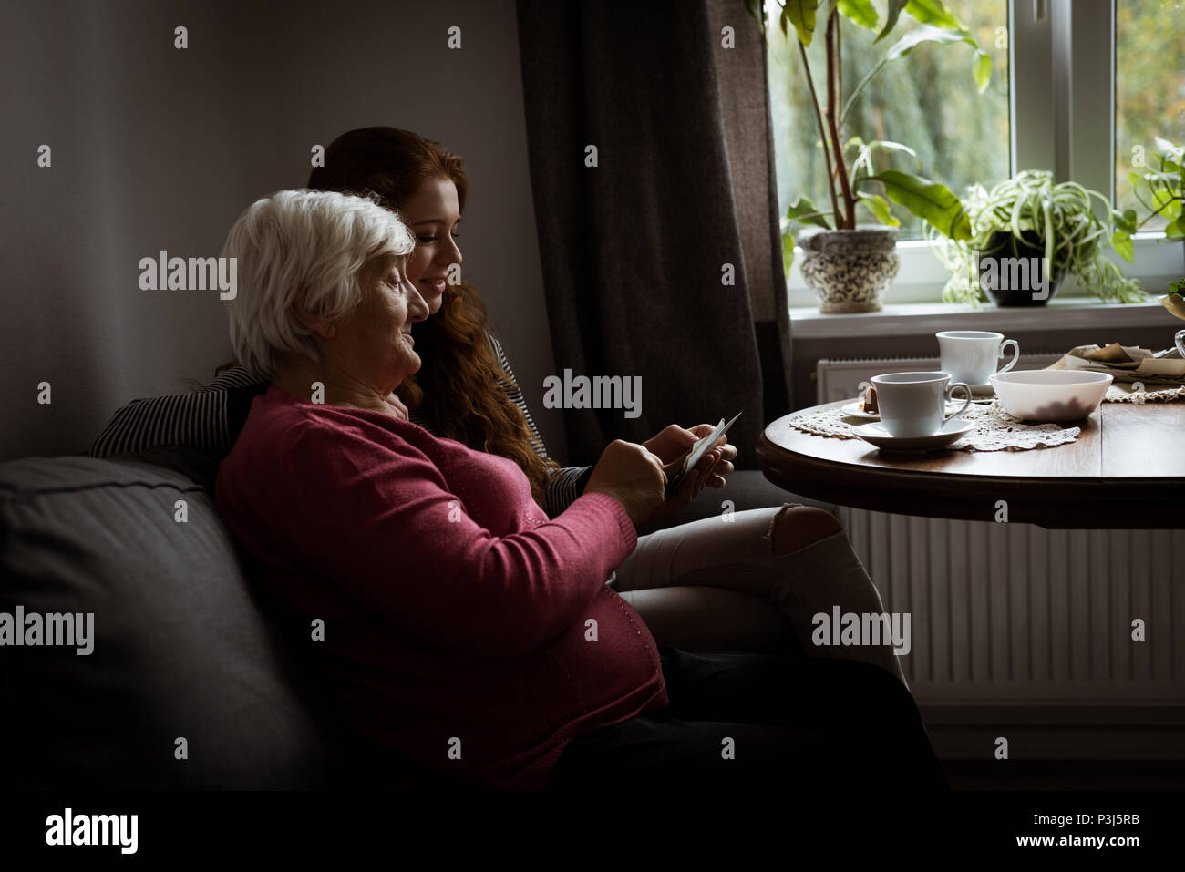 Grandmother and grand daughter looking at the photo Stock Photo