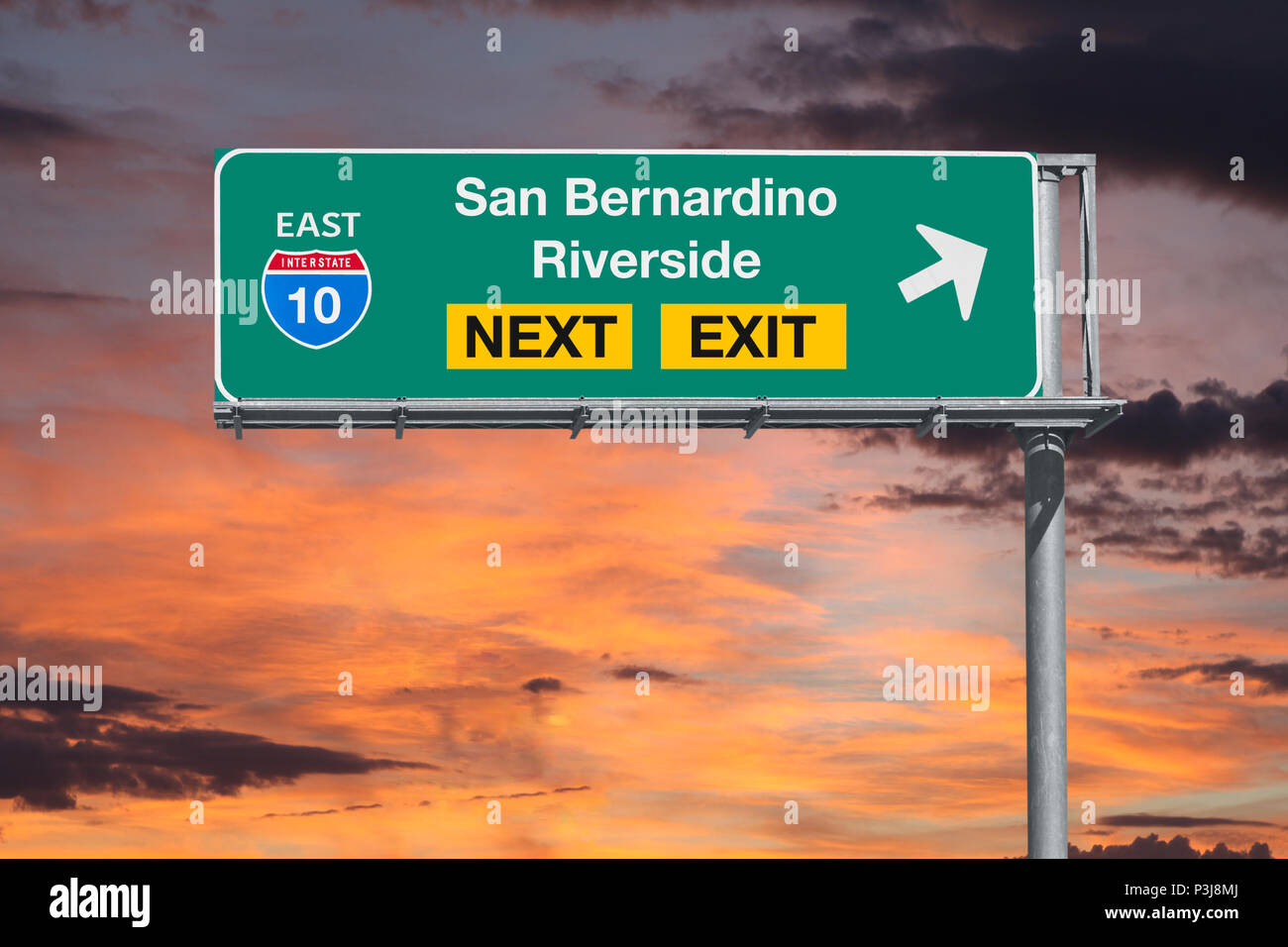 San Bernardino and Riverside California route 10 freeway next exit sign with sunset sky. Stock Photo