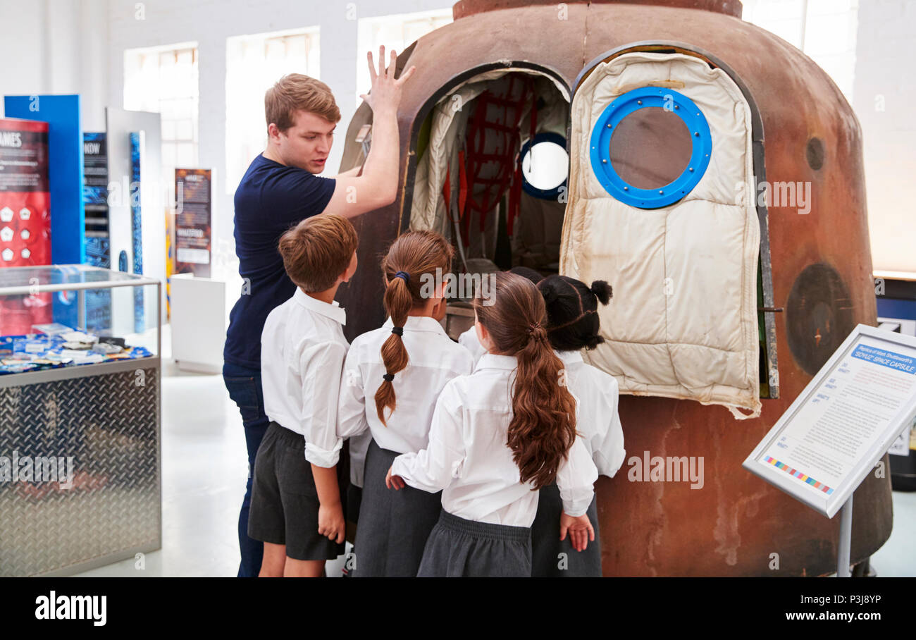 Kids and teacher look at a space capsule at a science centre Stock Photo