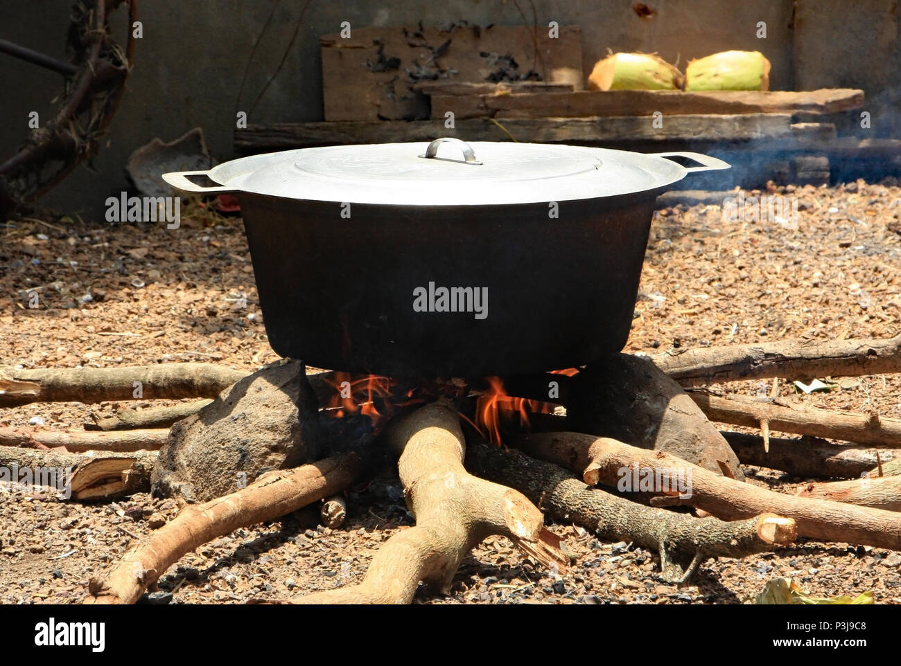 The cooking for a Cambodian wedding is done outdoors over fires that burn all day with huge pots of food above. Stock Photo