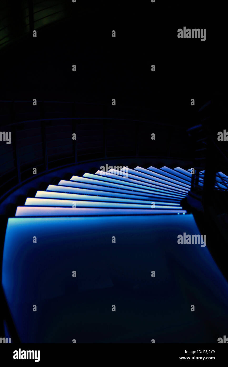 Looking down spiral stairs at night Stock Photo