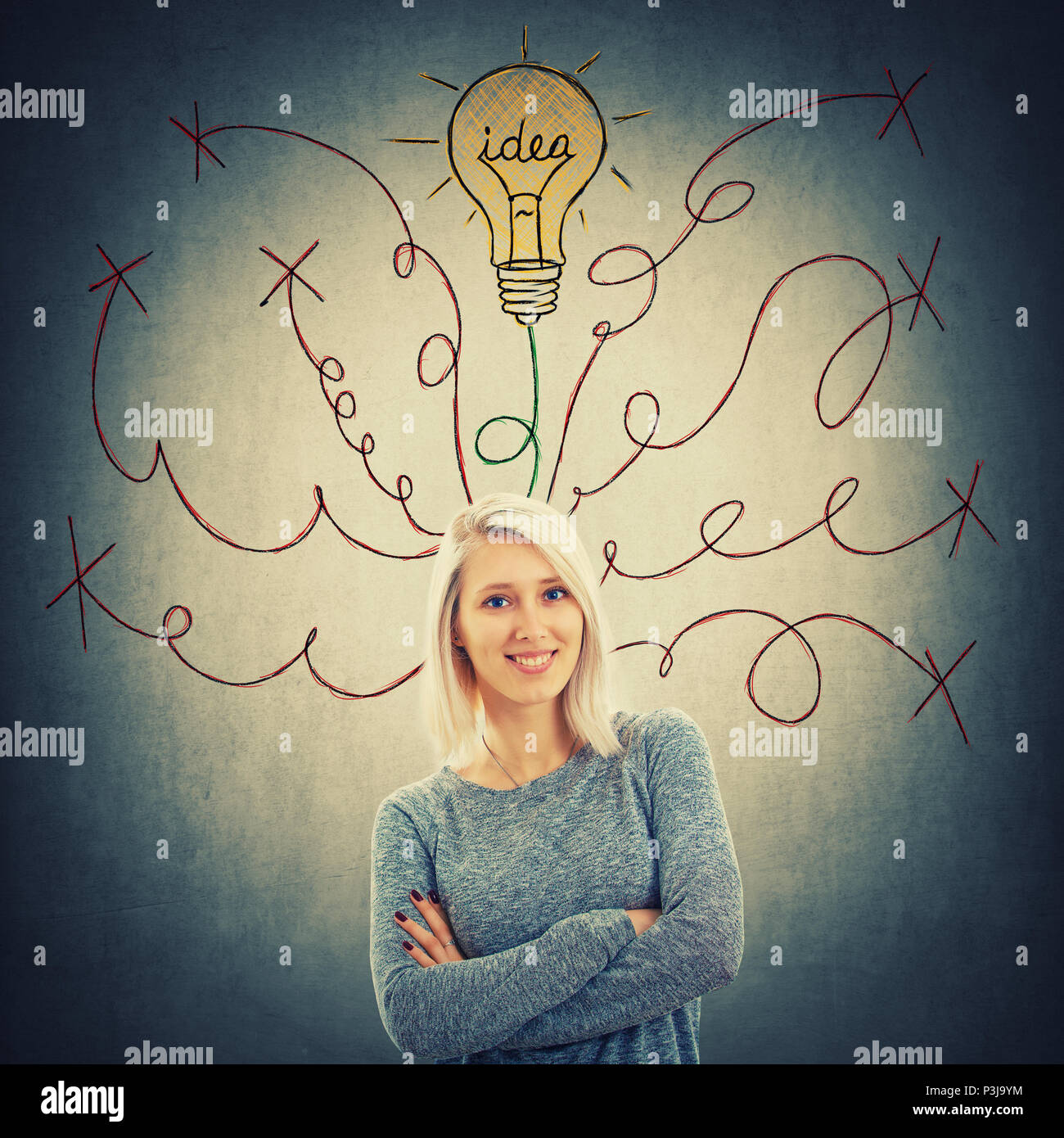 Cheerful woman with blue eyes and crossed hands has different lines as thoughts escaping above head, one of them transform into light bulb. Rich imagi Stock Photo