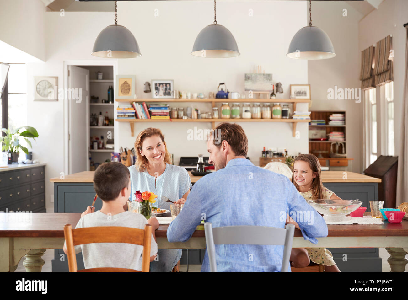 White family of four having lunch in their kitchen at home Stock Photo