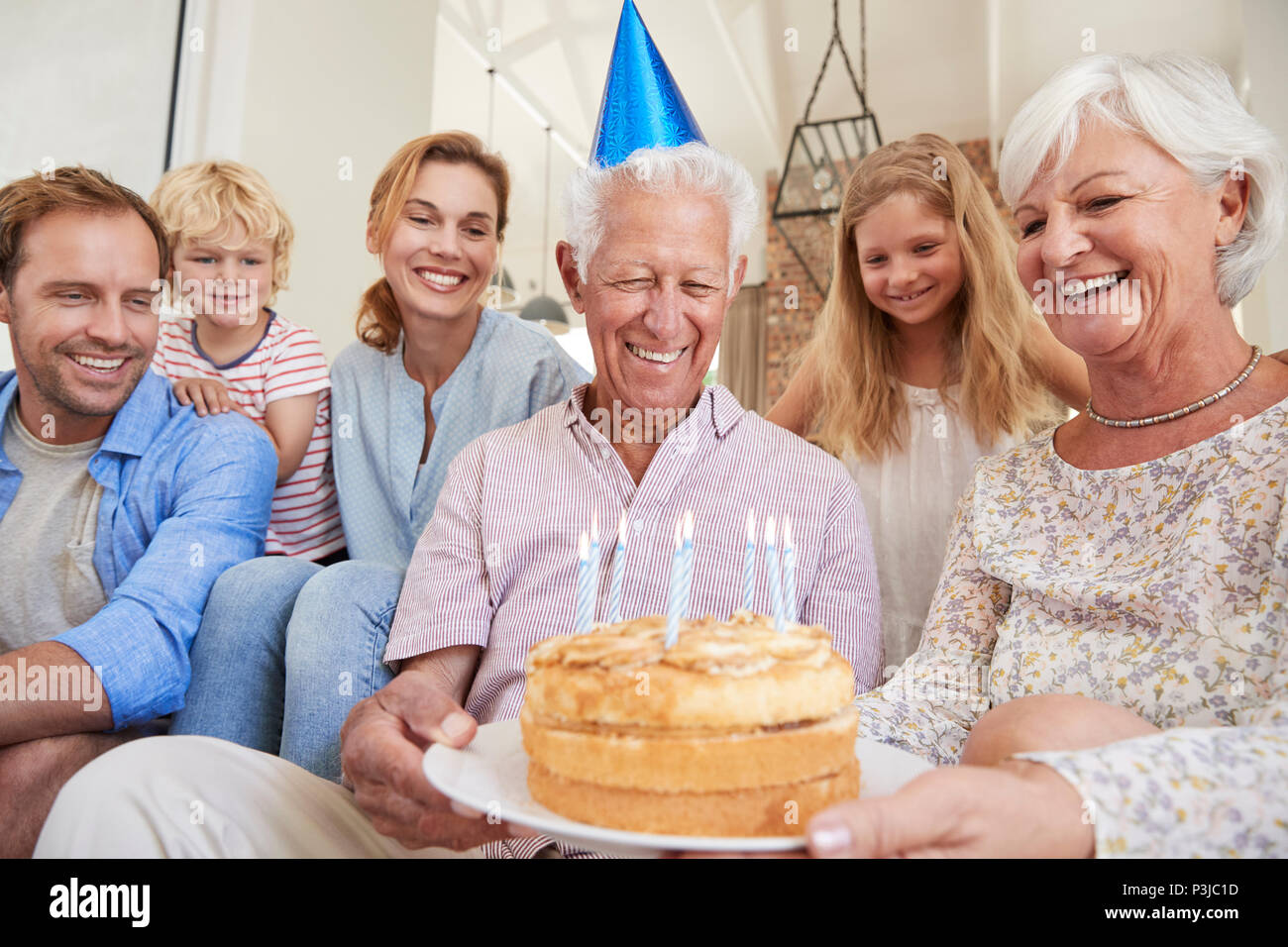 Multi generation family celebrating grandad’s birthday Stock Photo