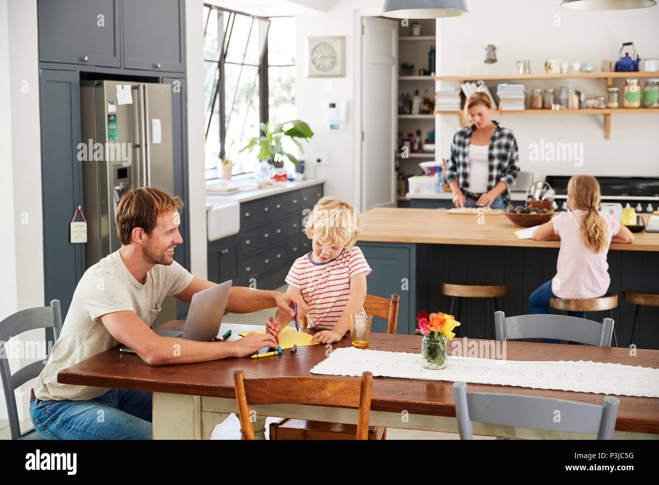 Young white family busy in their kitchen, elevated view Stock Photo