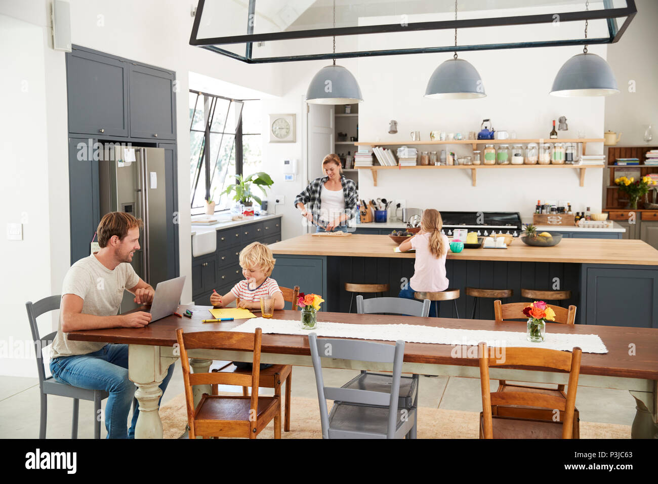 Young white family busy in their kitchen, elevated view Stock Photo