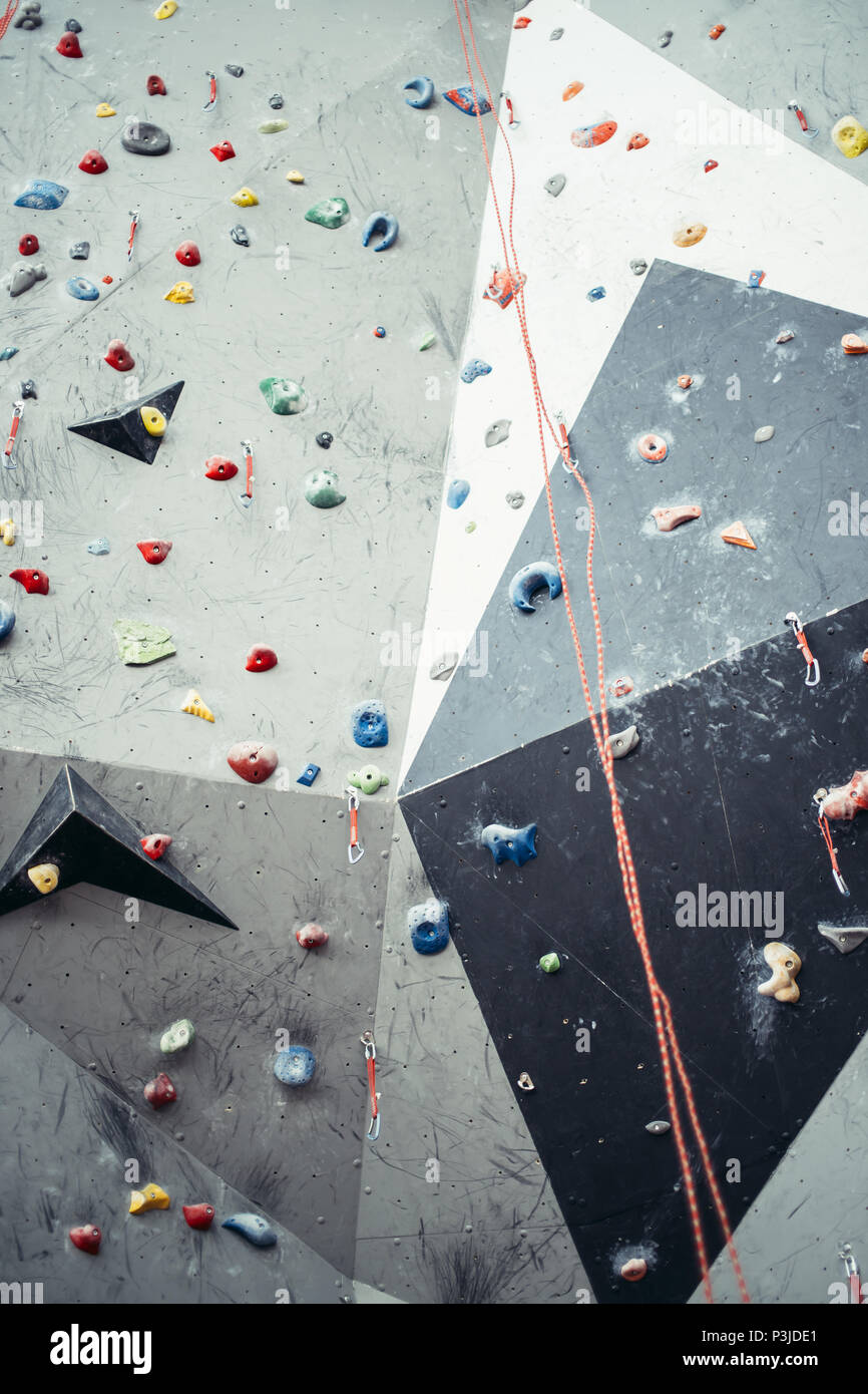 Artificial rock climbing wall with toe and hand hold studs Stock Photo