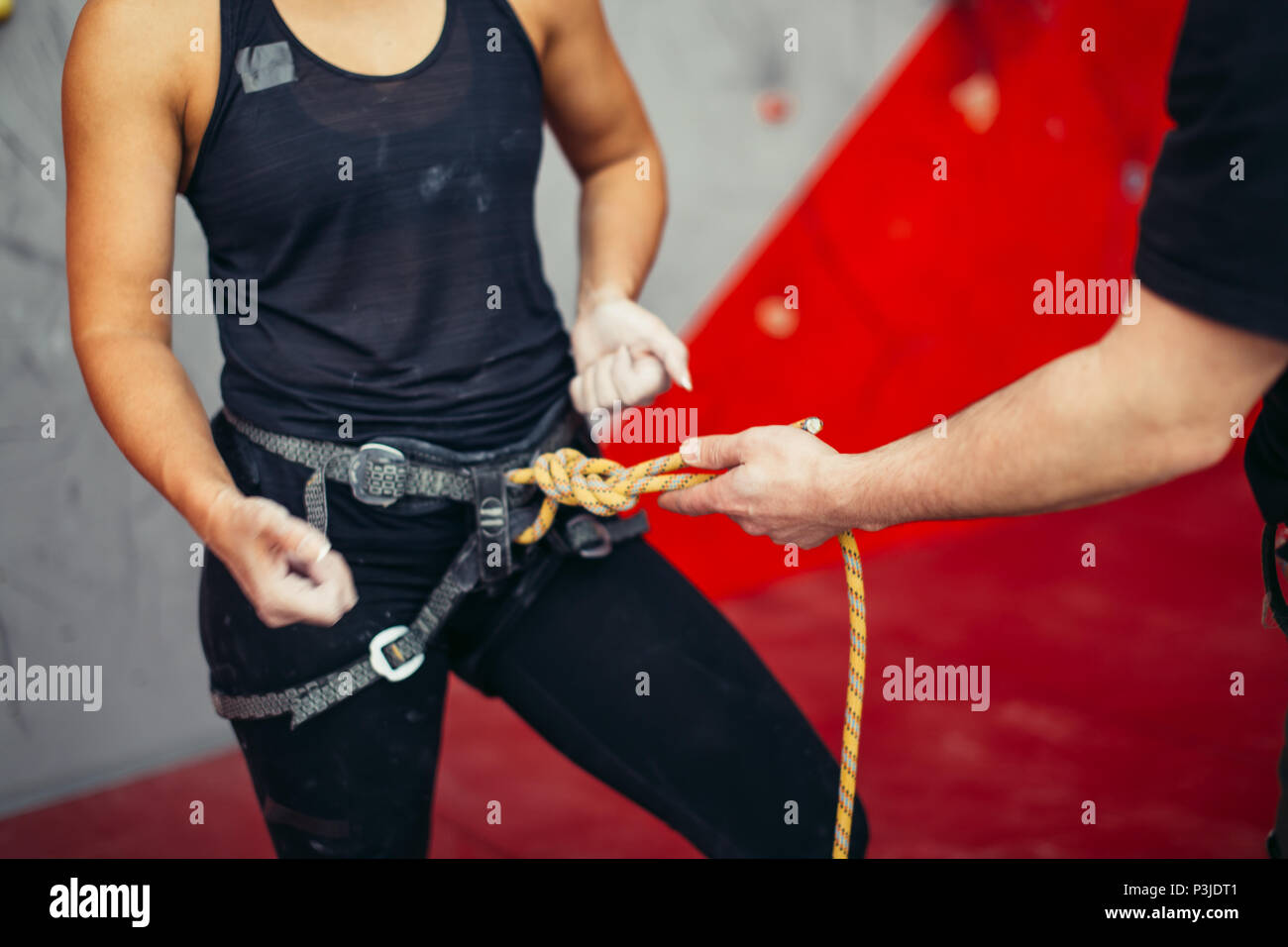 Rock climbing instructor is teaching how to tie the figure eight knot