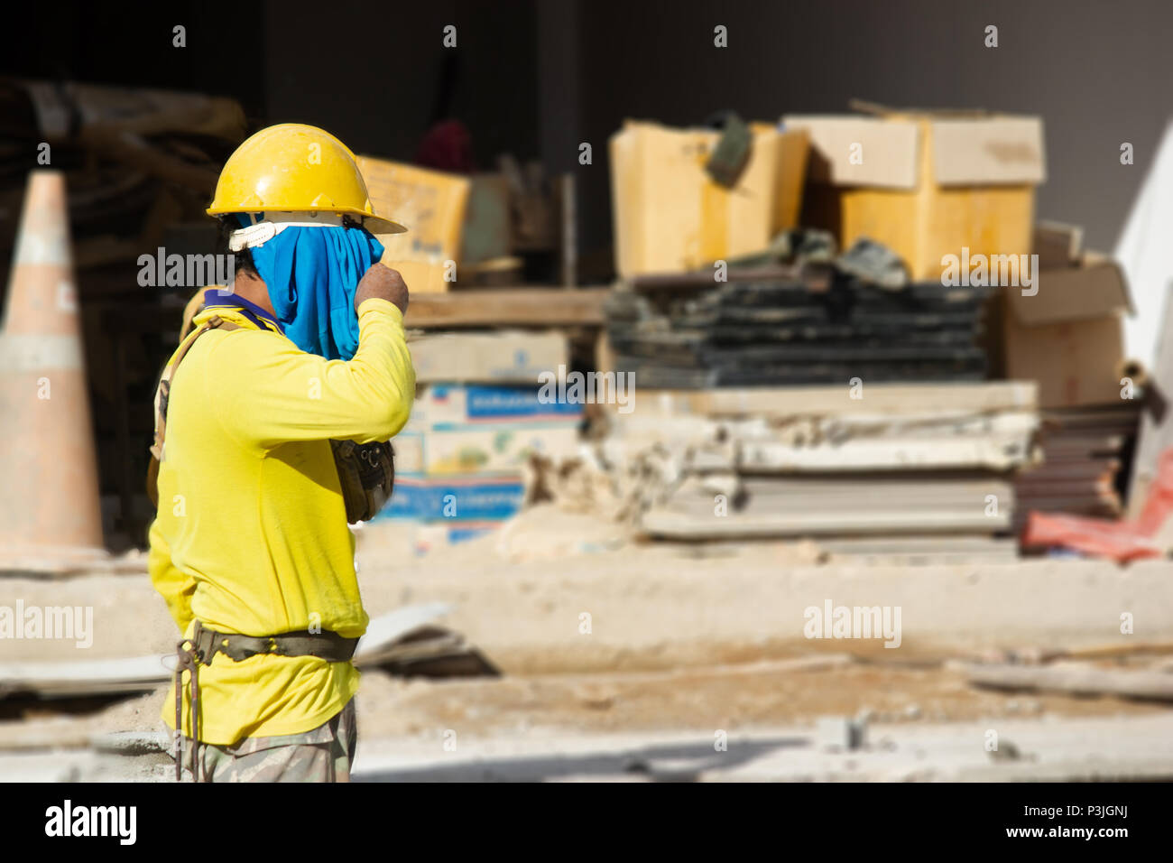Mason or Brick builders are building cement brick wall in construction site.  Workers are building buildings or buildings for housing. Stock Photo