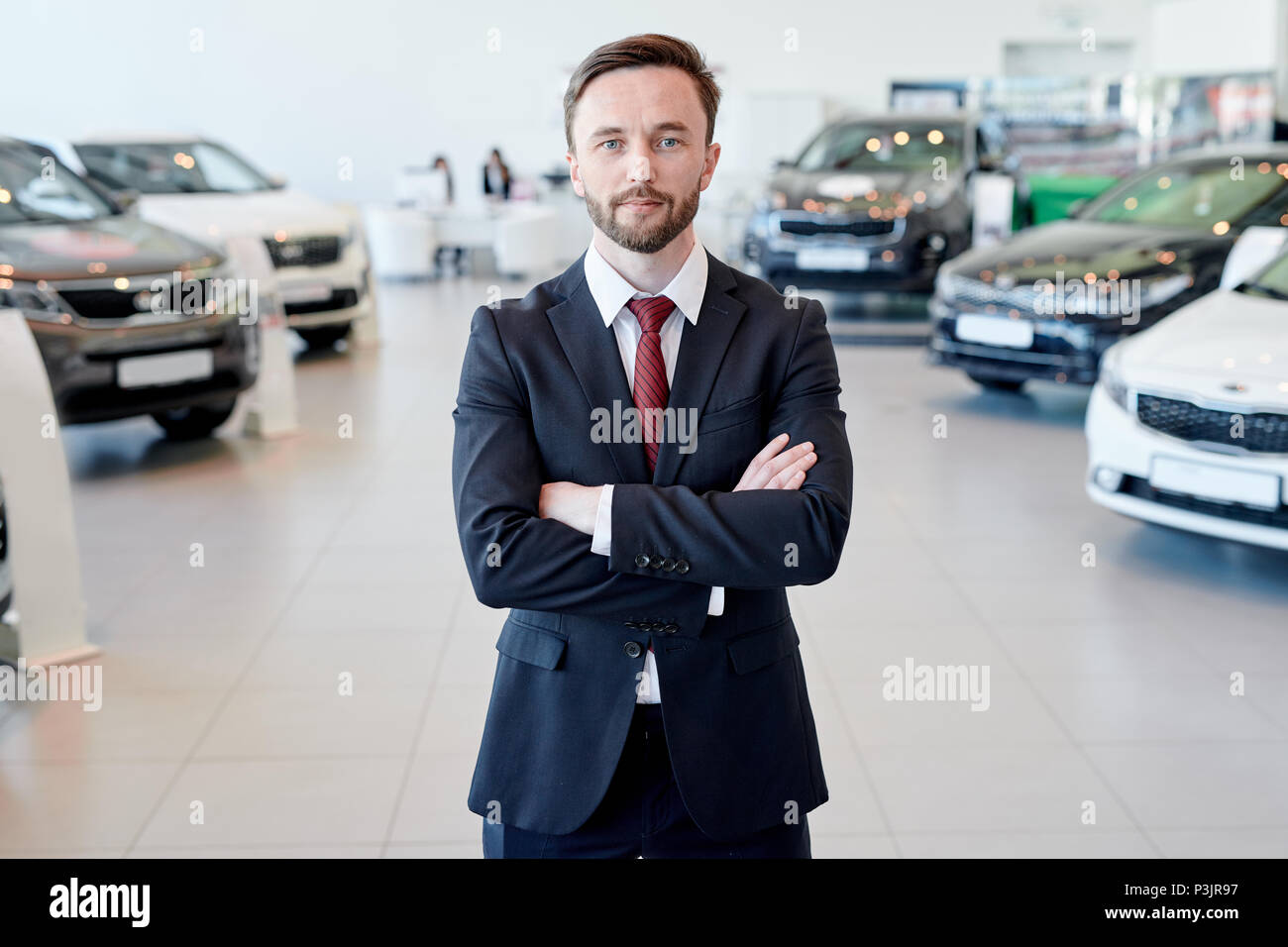 Car Salesman Posing In Showroom Stock Photo Alamy