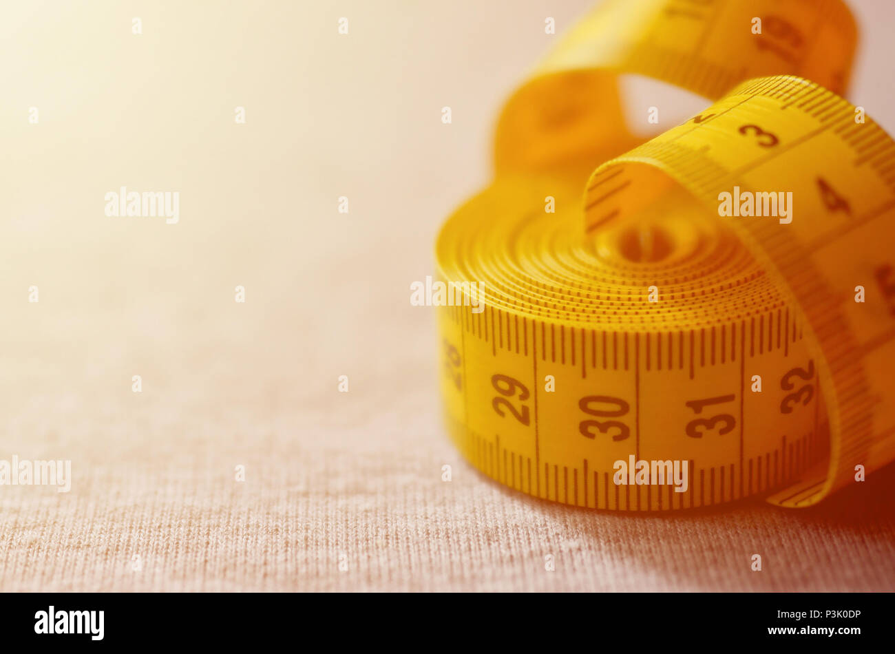 Yellow measuring tape lies on a gray knitted fabric 14502822 Stock Photo at  Vecteezy