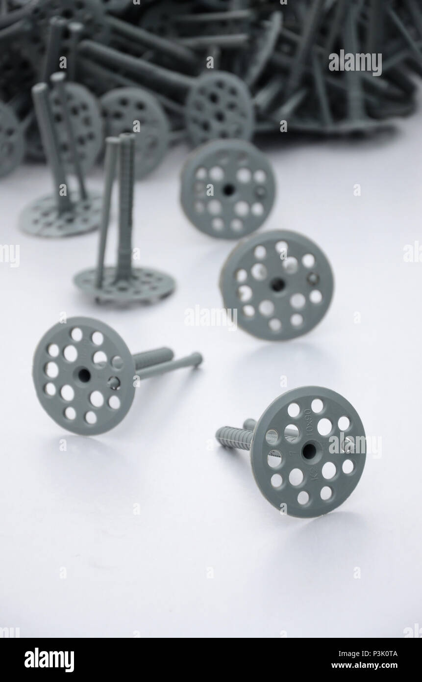 A gray plastic dowel (fastening) for thermal insulation with round