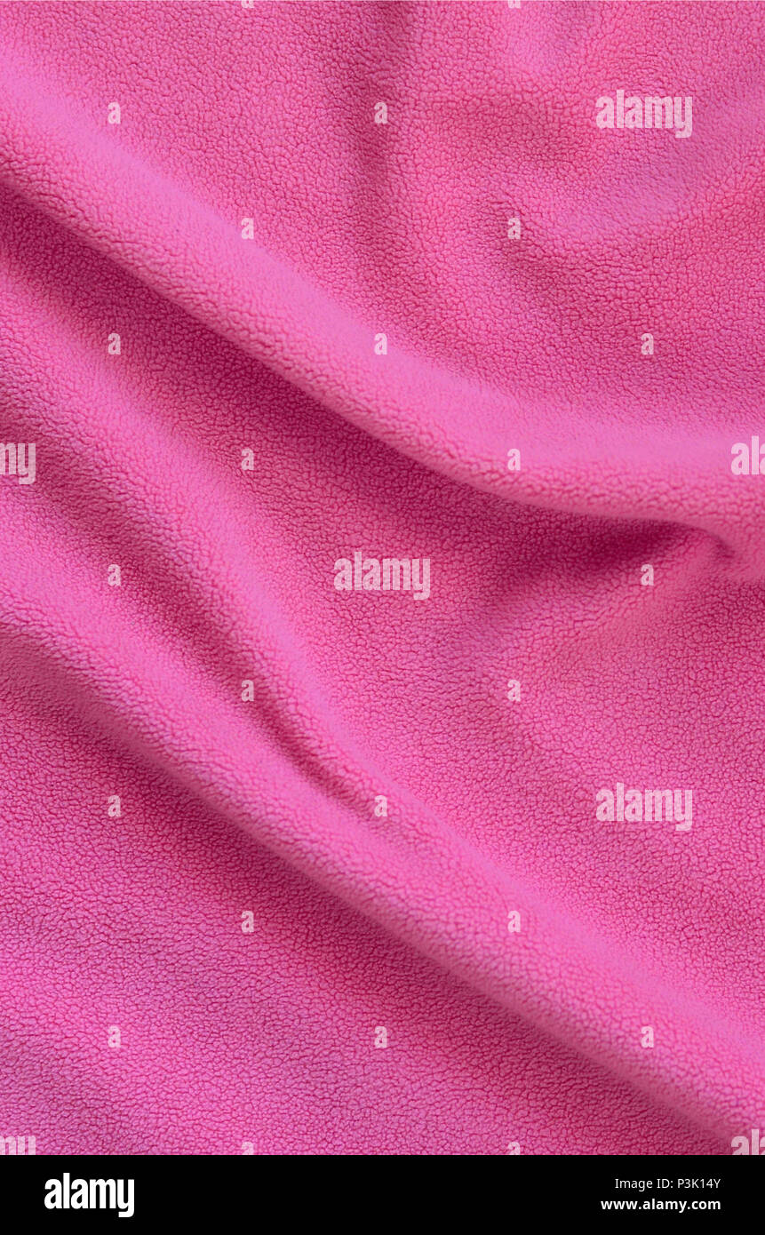 The blanket of furry pink fleece fabric. A background of light pink